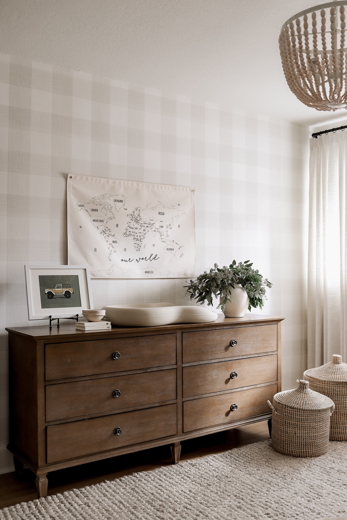 A moment for this dresser because it’s my all time fav and just *restocked* 😍

I always have to note that this is the true color! The online photo makes it look like a very light wood tone 🤔 I was shocked when I ordered this a few years back, but I love the rich wood tone after all! 

Additional Product Details:
•Wallpaper: I used the spray and stick rather than the peel and stick per the recommendation of my wallpaper installer
•Art: 14x11” with mat 
•Rug: Oatmeal