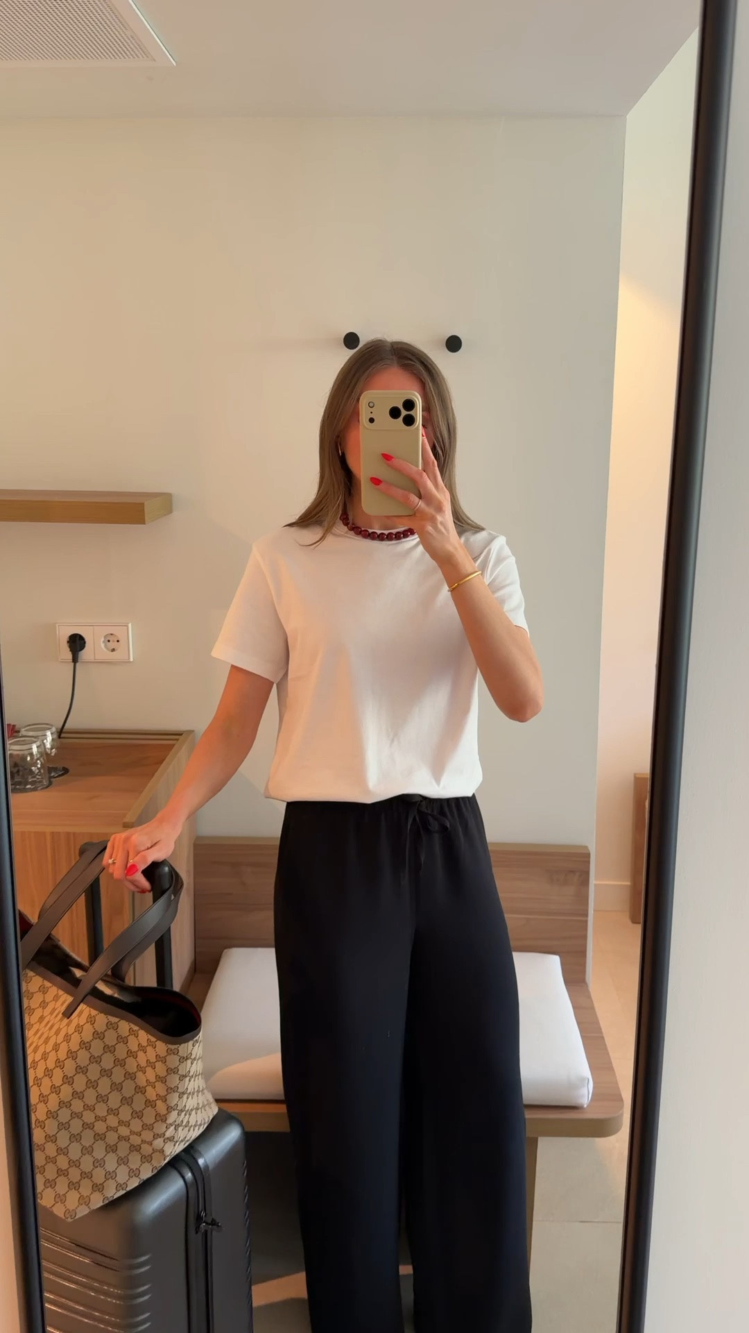 Airport outfit
Small in the & other stories white t-shirt
& other stories red beaded necklace
Aritzia the lodge pants - black creppette 
I wear the small reg & I’m 5ft 6 
Brown Birkenstock Eva 
Gucci tote bag