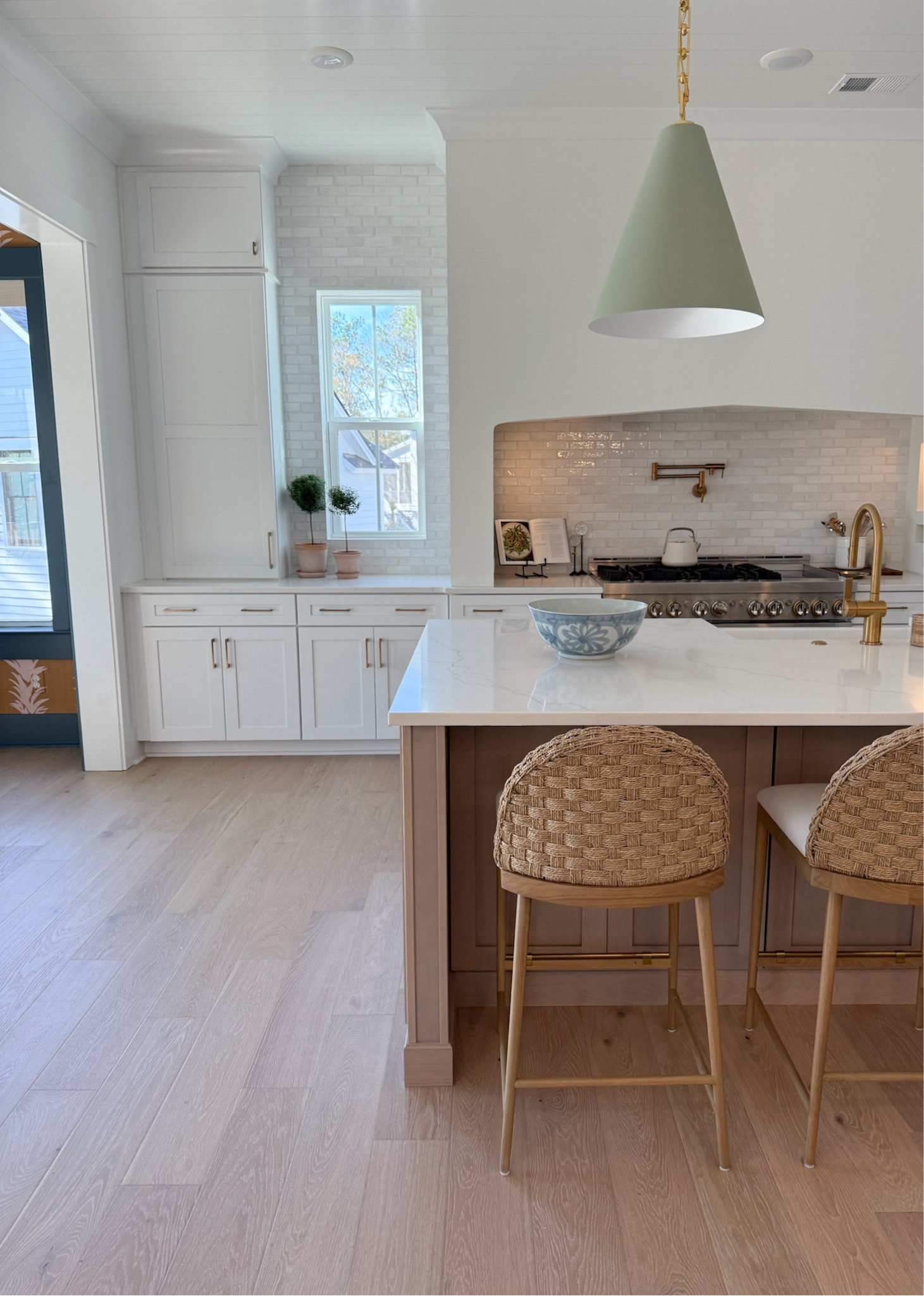 Visual comfort Theo pendant in celadon green and McGee and co Molly counter stool. White lotus wallpaper. 

White kitchen, white oak island, visual comfort, McGee and co, Jackie Joyce designs. 