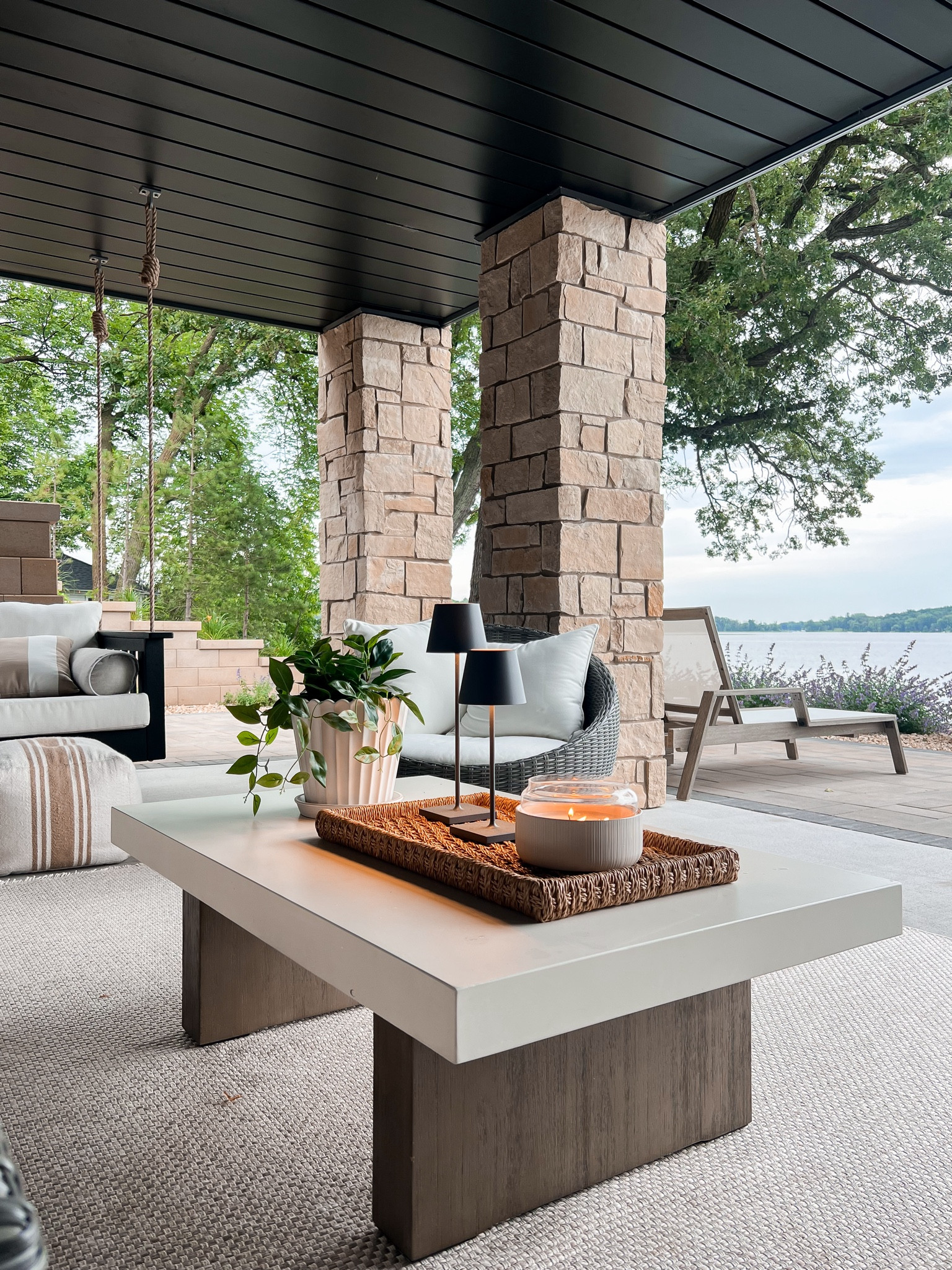 Outdoor coffee table styling at the lake house! The prettiest concrete coffee table , citronella candle and wire light lamps make for the perfect summer evening! 

#LTKHome #LTKStyleTip #LTKSummerSales