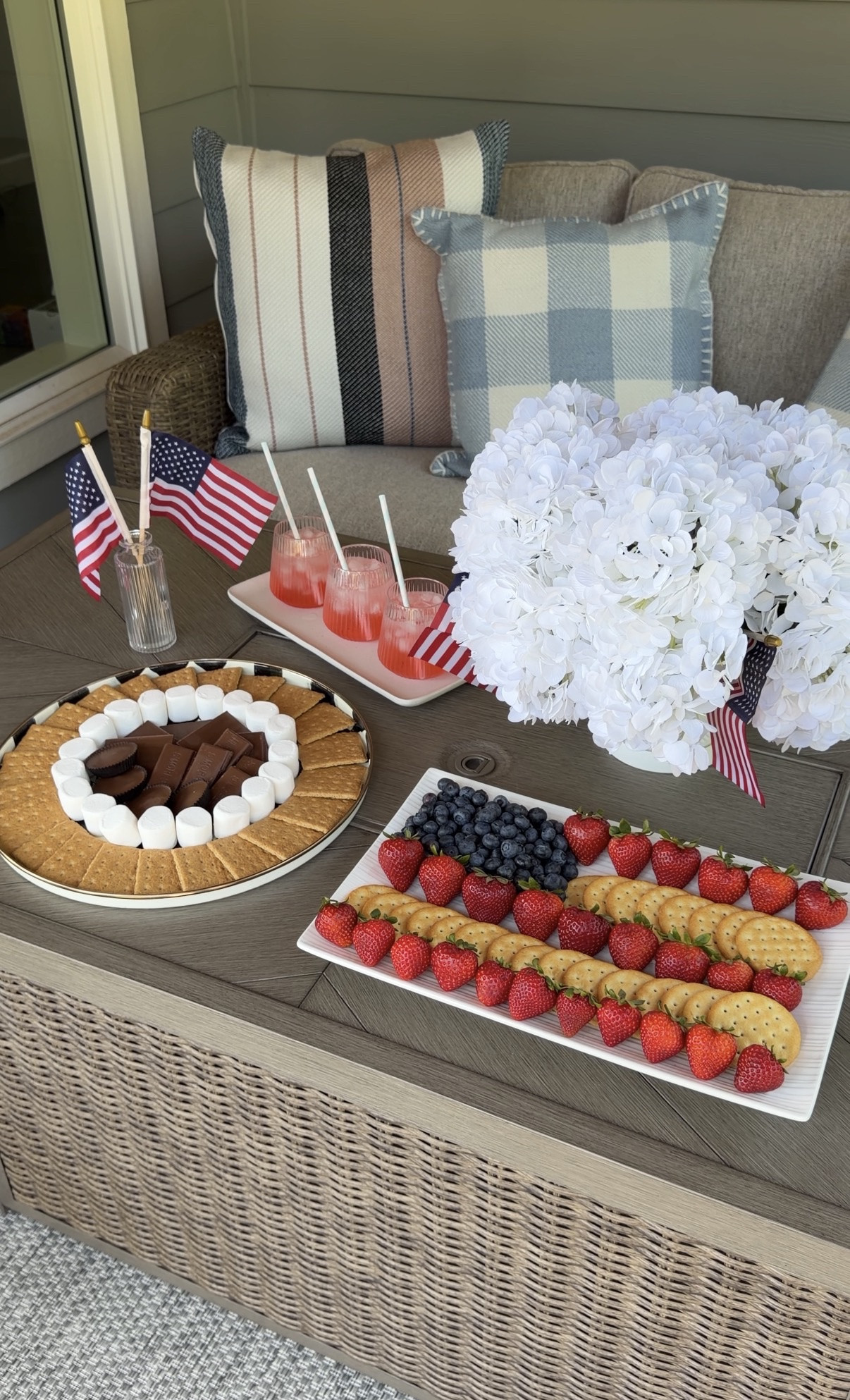 July 4th patriotic front porch outdoor furniture set up! USA American flag garland with fire pit patio table! 

Fire pit table, straws, plate, tray, pillows, rug, flag picks, bud vases, hanging basket, outdoor sofa, glasses, vases, hydrangeas, American Flag banner

#LTKfestival #LTKhome #LTKsummer