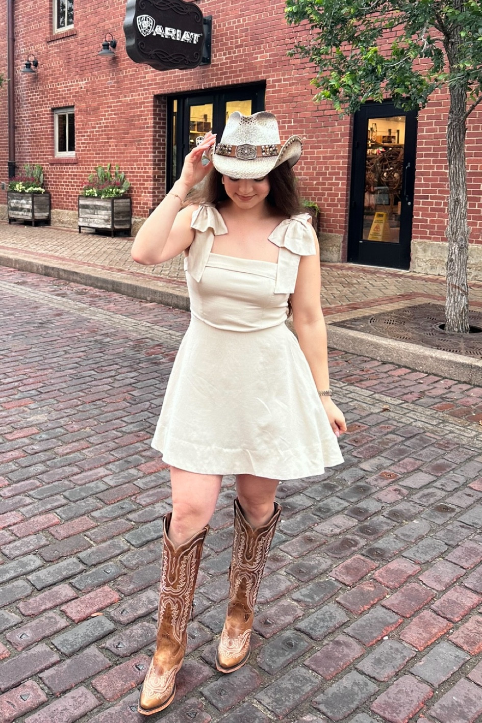 Cowgirl dress. Flowy dress. Girly dress. Ivory dress. Cowgirl outfit. Cowboy outfit. Shoulder bow knot accent dress. Cowboy boots. Tall cowboy boots. Cowgirl boots. Ariat boots. Cowboy hat  

#LTKShoeCrush #LTKStyleTip #LTKFindsUnder100