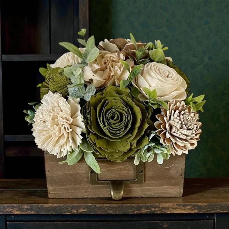 This sweet sola wood flower arrangement is a beautiful way to bring handcrafted charm into your home. Made from the natural root of the tapioca plant, each bloom features soft ivory petals with subtle earthy tones that highlight the organic character of the wood. Carefully hand-dyed, fluffed, and arranged, this petite display makes a thoughtful gift or a timeless decorative accent that adds warmth and texture to any space. #LTKhome #solawoodflowers #handmadehome #rusticdecor #naturaldecor #giftideas #floraldecor #neutraldecor #artisanmade #homestyling

#LTKHome #LTKWedding #LTKSeasonal