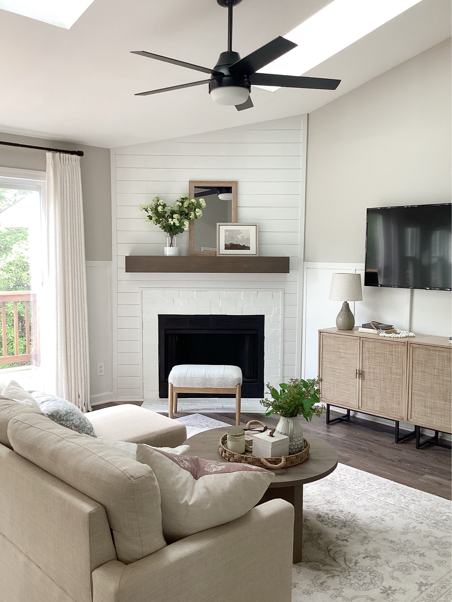 Living room 
Spring home decor 
Faux florals 
Corner fireplace 
Neutral home 

#LTKSeasonal #LTKhome #LTKstyletip