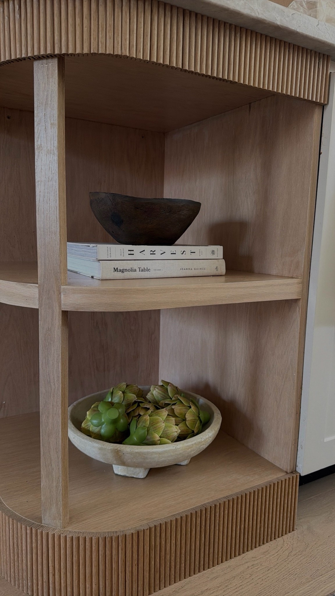 Kitchen shelf styling ft the amazon faux artichokes I love! 

Cookbooks, carved wood bowl

#LTKHome