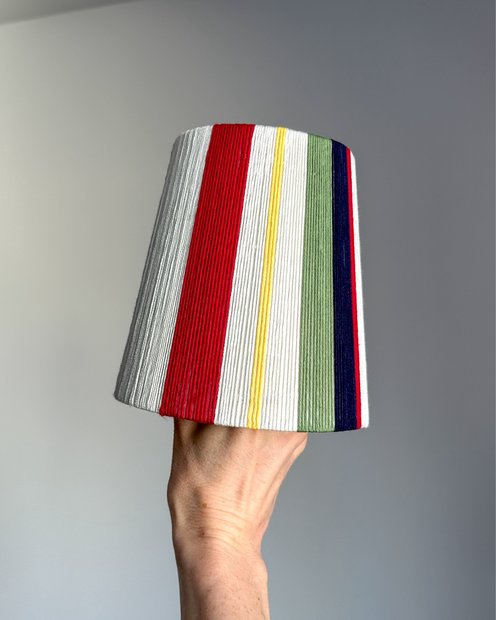 No skill necessary, $10 colorful lampshade DIY. All you need is embroidery thread in the colors of your choosing and a lampshade. This is a perfect way to upcycle a cheap thrifted lampshade, and I love how it can be customized to suit any style. 

I’m linking all of the thread colors I used to create mine (there are a lot of shades to choose from so get these exact ones if you want to create the same look). I needed a total of 9 (across 5 colors) for a small lampshade (7” on the bottom, 4” at the top, height of 6”). I already had a hot glue gun, but if you don’t have one, you’ll need that too, and I promise you’ll find other uses for it.

#LTKhome