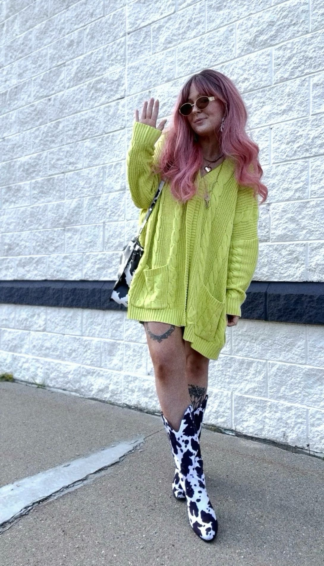 Lime green cardigan 
cow print cowgirl boots 
Cow print purse