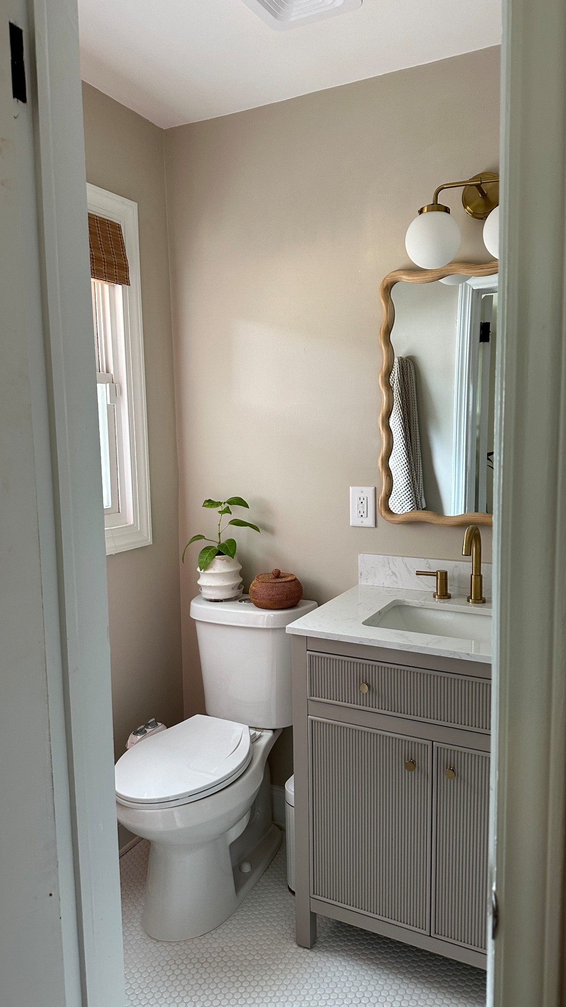 neutral modern bathroom inspo 

scalloped mirror, fluted vanity, Behr even better beige, bathroom reno, bathroom makeover, small bathroom design inspo 