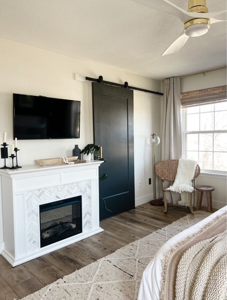 In this bedroom makeover I did - we added an electric fireplace for an extra cozy vibe! We also replaced their bathroom door with this barn door and painted it to keep it modern. Bedroom decor, bedroom inspo 

#LTKFind #LTKhome
