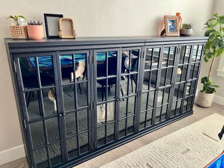 My 95” wide black sideboard. Comes in 2 pieces so you can change the way you display it. 8-door buffet offers lots of storage. Has a scratch- and water-resistant finish, it features eight tempered glass doors that stretch all the way to your dining or living room floor. Inside, 16 internal shelves provide plenty of space for dinnerware, collectibles, or books. Plus, there's lots of room on the spacious surface for accent pieces to display  

#LTKHome #LTKSaleAlert