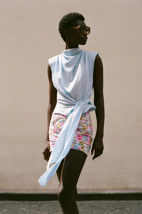 High neck top, sleeveless with shoulder pads and pleats. Hem with tie. Back opening with conceale... | Zara US