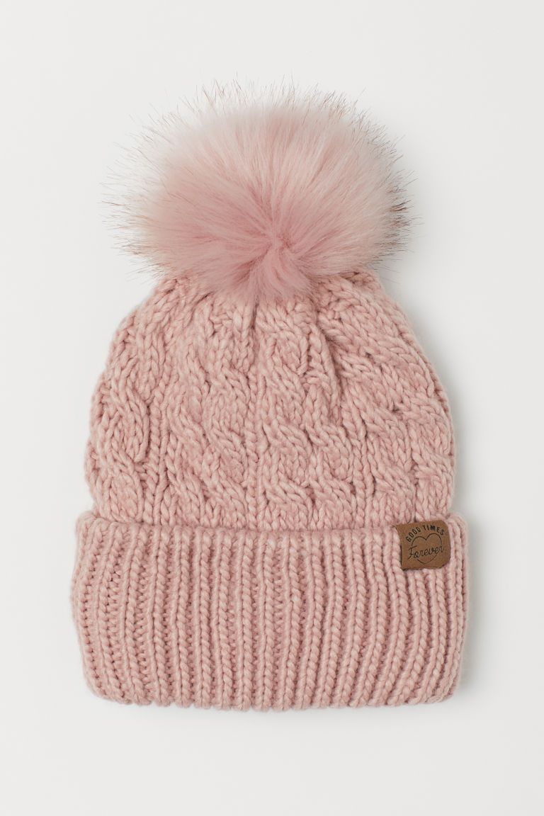 Soft, cable-knit hat with a faux fur pompom at top and a ribbed cuff. Cotton jersey lining. | H&M (US + CA)