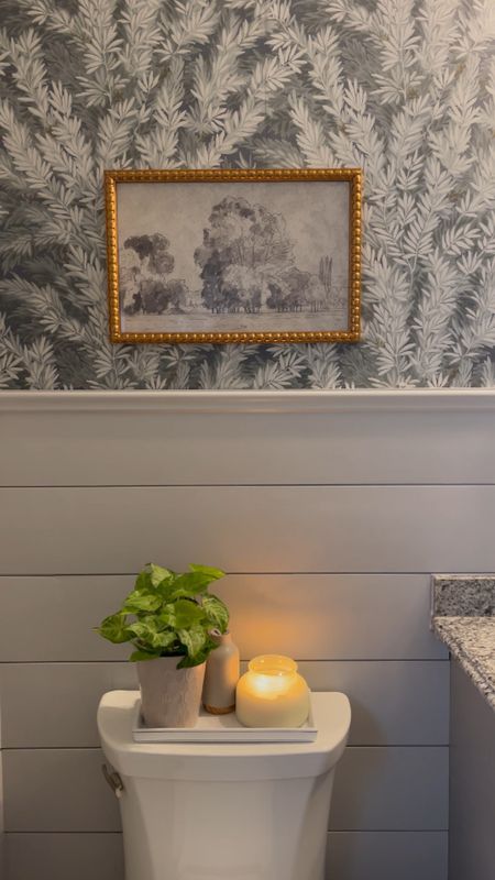 Cozy beautiful powder room 
Wallpaper, gray shiplap , vanity light, black faucet, bronze mirror 
Paint: Lamp Room Gray by Farrow and Ball 

#LTKstyletip #LTKhome #LTKfamily