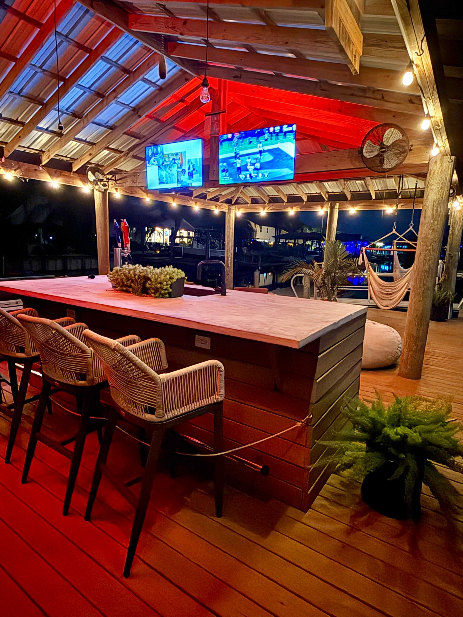 Christmas party entertaining hosting outdoors dock lights string lights color changing LED lights bar stools smart TVs 

#LTKHoliday #LTKParties #LTKHome