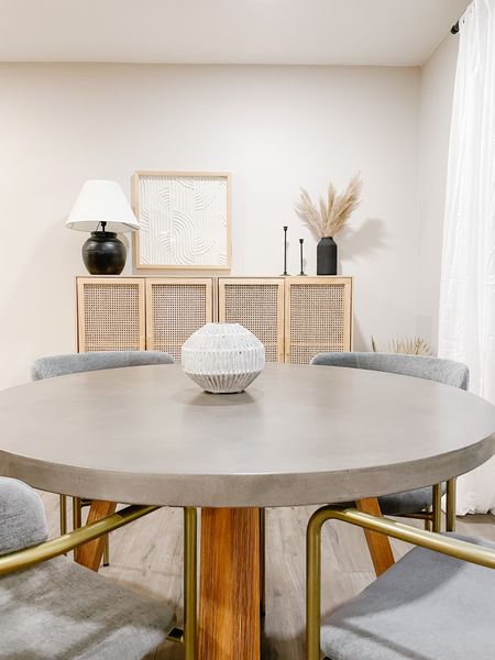 With a cool concrete top and warm wood base, this round table is a gorgeous option for a mid-century dining space.✨

#arizonahome

#midcenturyhome
#ltkhomestyle
#roundtable
#golddiningchairs
#midcenturychairs
#woodtones
#concretetop
#rattanfurniture
#blackaccents

Concrete round table, brass chairs, mid-century chairs, rattan media console, black candle sticks, game table, black lamp, Target furniture, west elm chairs

#LTKsalealert #LTKhome