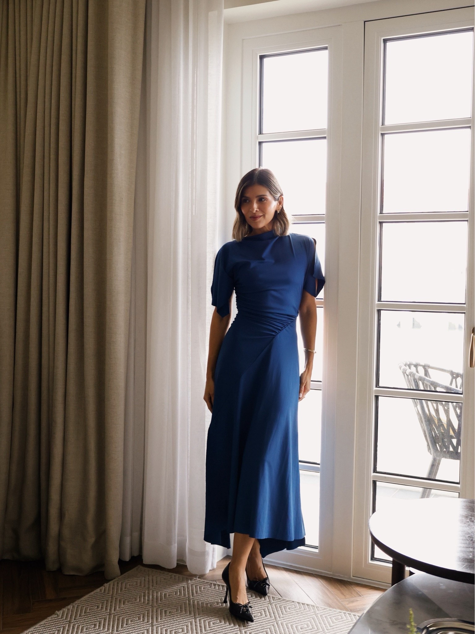 What I wore to Vogue Leaders Panamá. A navy draped dress, pointed-toe heels and minimal gold jewelry — linking the look + similar options.
