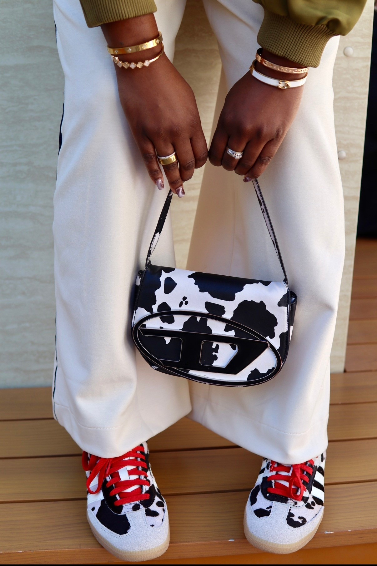 I love a good animal print . Today’s accessories is cow print 🖤 Adidas Samba , Wide Leg Sweat Pants , Oura Ring, Bracelet Stacks