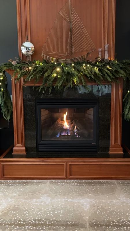 I’m still putting finishing touches on the fireplace mantle. The garland is new this year and I can’t get over how beautiful it looks. This is 4 strands. I added lights today and I’m thinking I’ll add some ribbon next!
kimbentley, holiday decor, living room decor, holiday garlandd

#LTKover40 #LTKHoliday #LTKhome