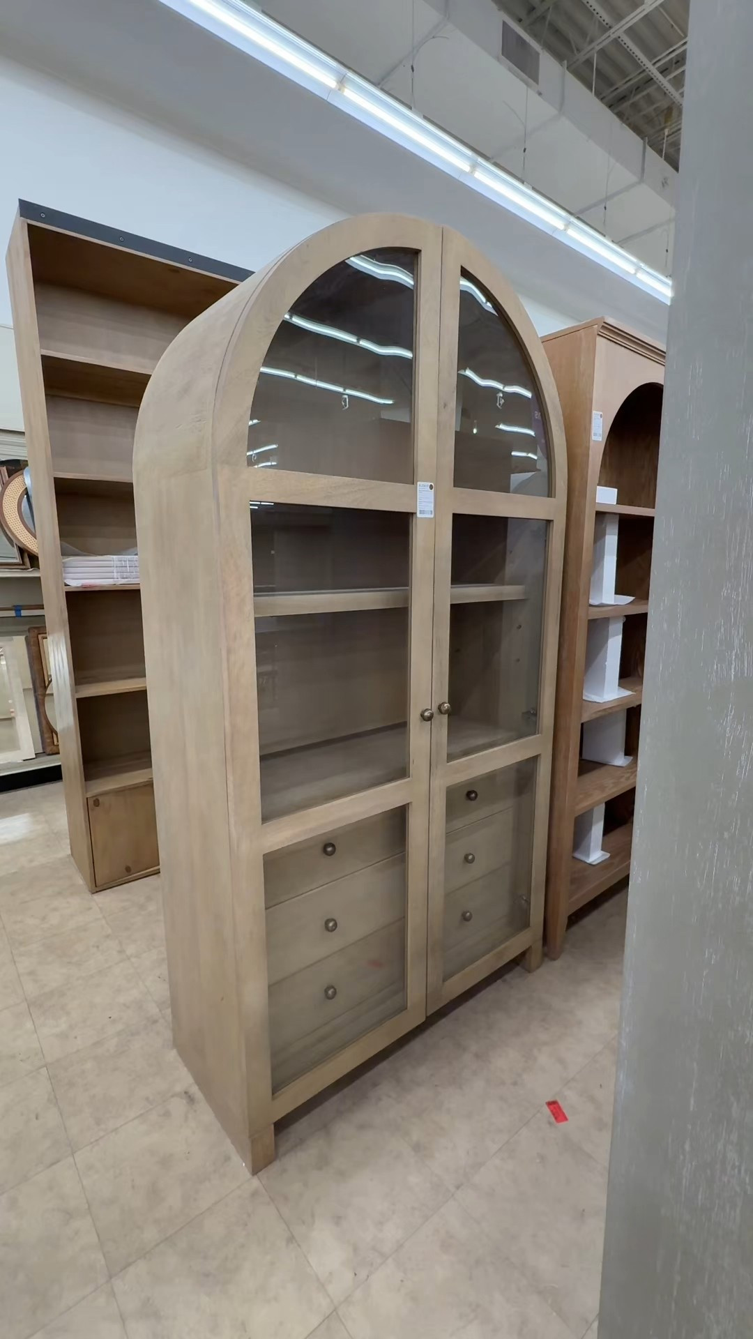 Showing off the storage side of this piece! The Stonewall 80” Curio Cabinet form Wayfair is such a smart mix of display + function. 🫶🏻 Adjustable shelves give you tons of flexibility for styling books, ceramics, or serveware, while the bottom drawers are perfect for hiding everyday clutter. ☺️ It holds a lot without feeling bulky, and the glass doors keep everything looking light and intentional. Linked this cabinet and a few other similar arched storage styles! 🤎 #wayfair #archedcabinet #homeinspo

#LTKHome #LTKSaleAlert