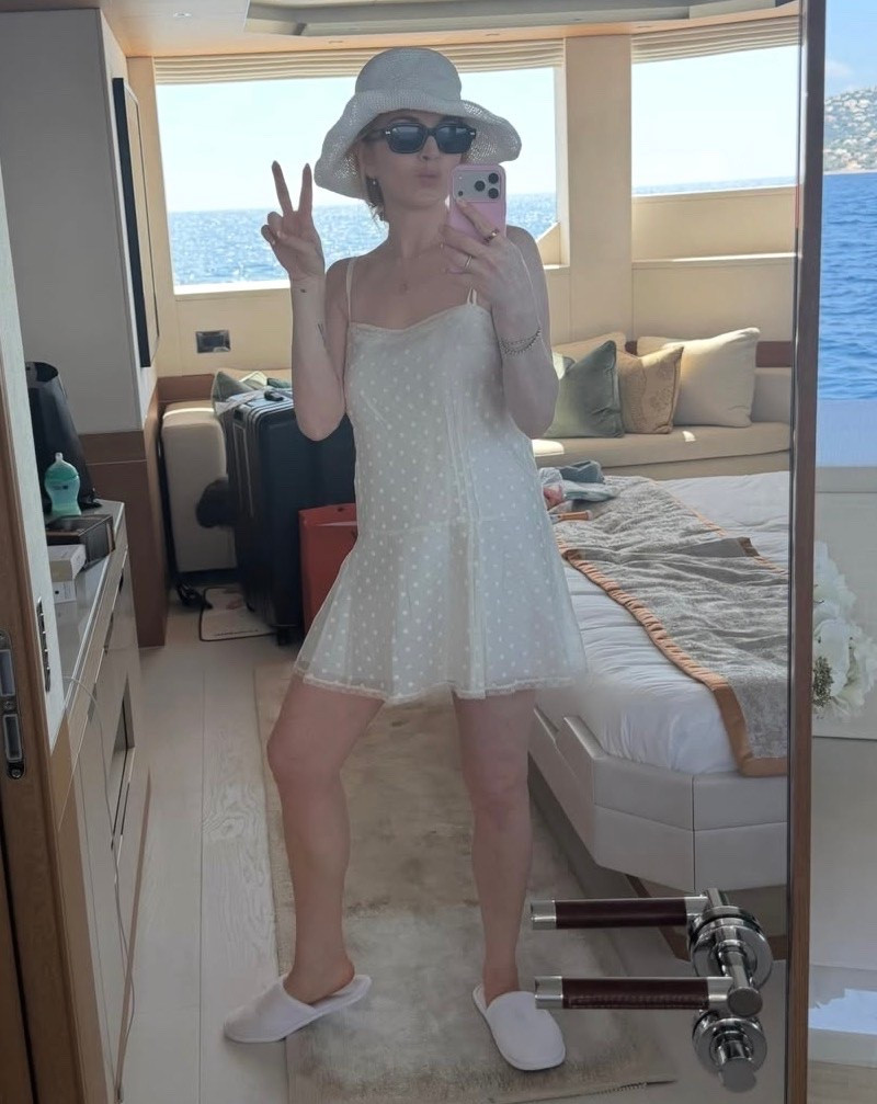 Lindsay Lohan's is a sleeveless mini dress with a curved neckline and lace detailing. Designed for special occasions, or regular ones where you just want a little extra attention.