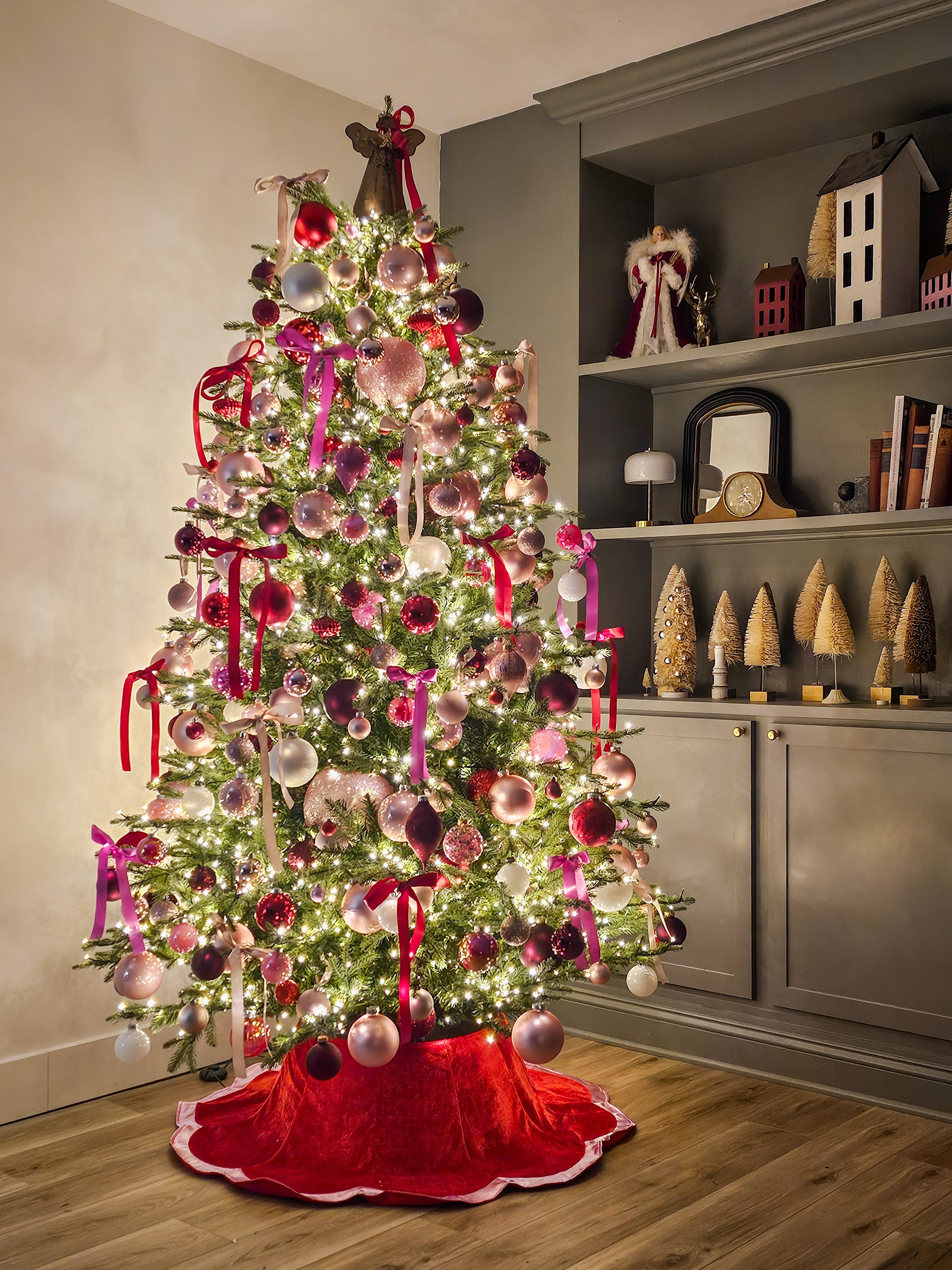 Pink and red tree in basement 

#LTKHoliday #LTKHome #LTKSeasonal