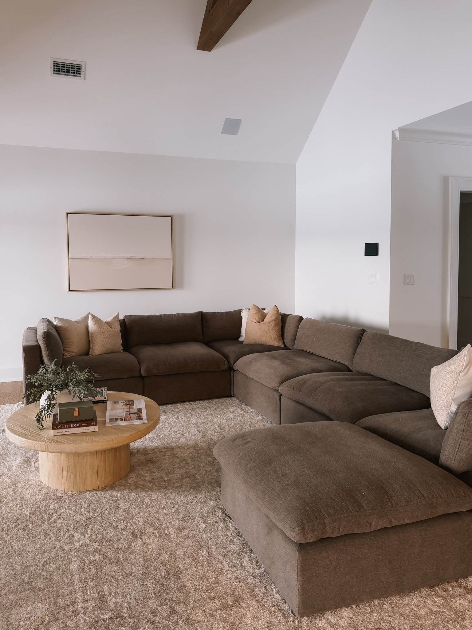 A cozy brown living room with a modular section WITH a storage ottoman… YES 👏🏼

#LTKHome #LTKSaleAlert