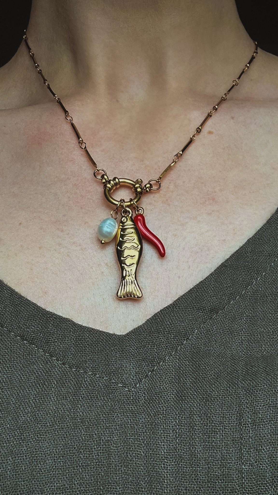 I found this cute faux gold summer statement necklace, dawning a fish charm, a pearl charm, and a cute little red hot chili pepper charm. It is less than $20! 

#LTKFindsUnder50 #LTKStyleTip #LTKSummerEdit
