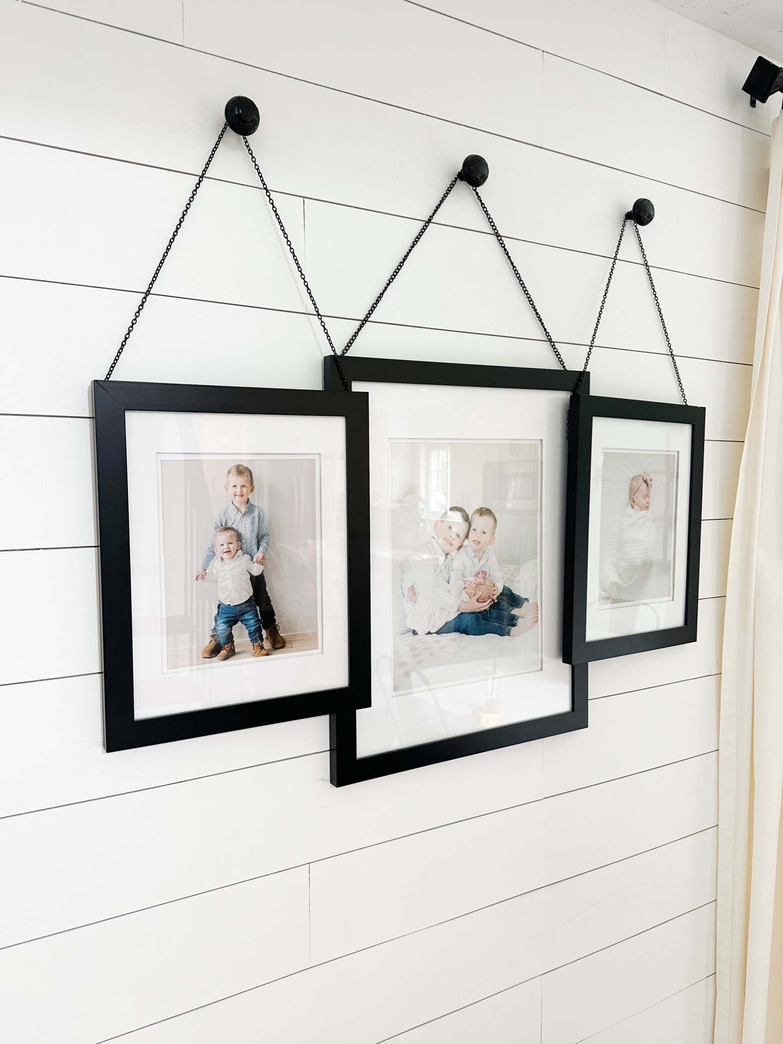DIY hanging frames pottery barn dupe

I used one 11x14 picture with mat in the middle and 8x10 picture with mat on the sides. Nailed the chains to the back of the frames and hung them on black knobs. Easy!

#LTKhome