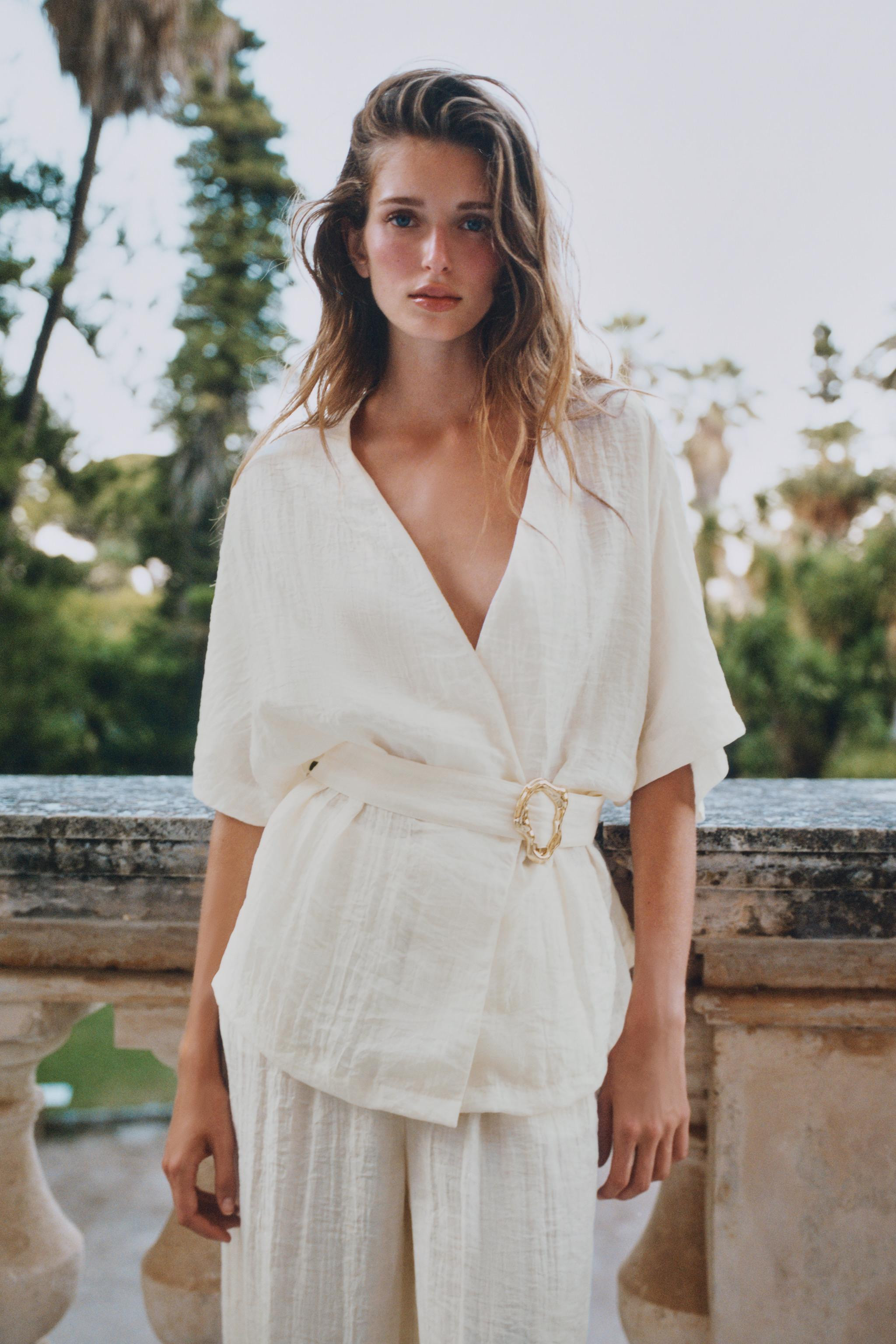 V-neck top with elbow-length sleeves. Waist with pleats and matching fabric belt with gold-toned ... | Zara US