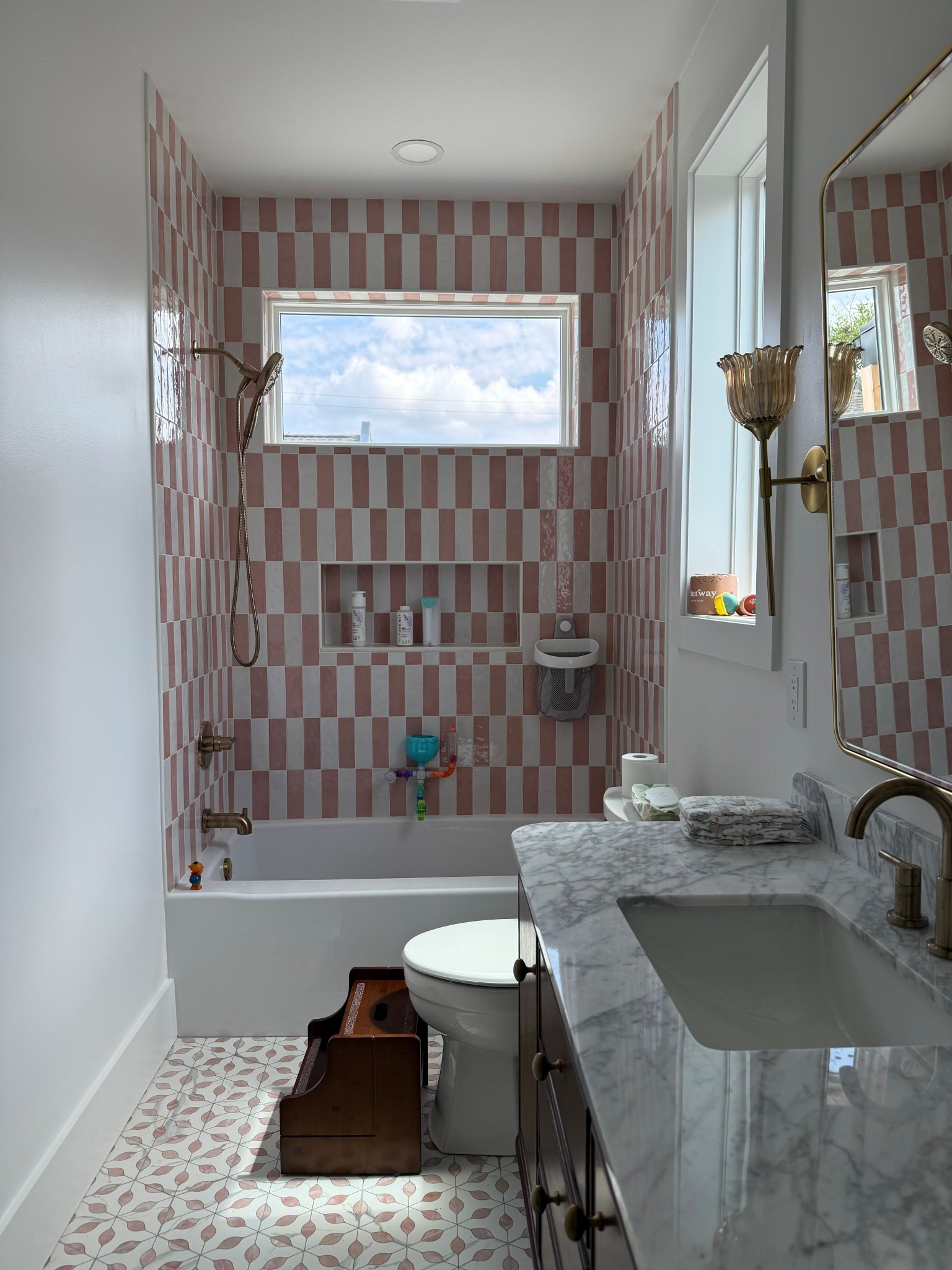 I finally have Winnie’s bathroom almost done! Look at how darling this is! The checkered pink and white tile, with the subtle designed tile on the floor! These beautiful flower sconce lights and this darling wood vanity! 
She even has a toddler transitional toilet seat making it easy for her or use to use the bathroom and the cutest little stool with a motion censored light! 

#LTKFamily #LTKBaby #LTKKids