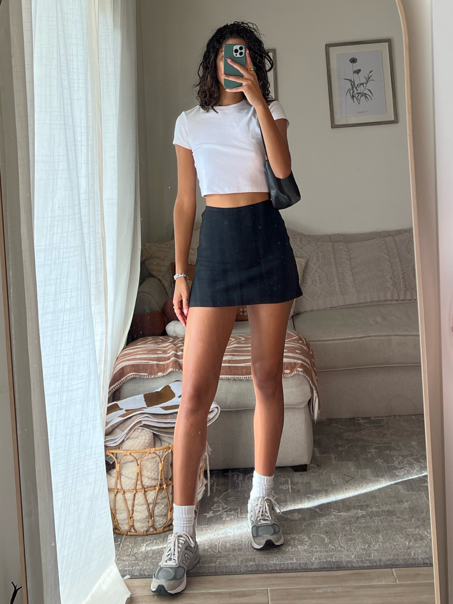 lunch outfit 👟
white crop top: cuts
A line black mini skirt: princess Polly 
Black shoulder bag: Ann Taylor (thrifted) 
dad Sneakers: new balance 