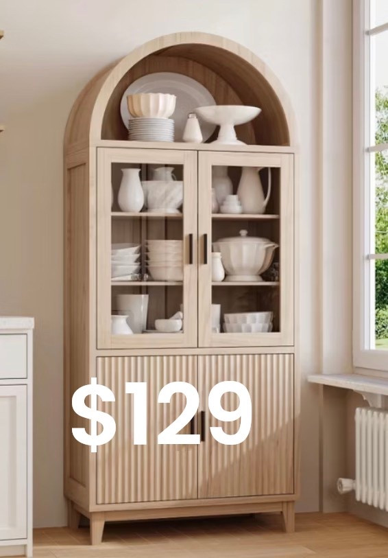 
A serene, light-filled interior featuring a tall arched light-oak cabinet with glass doors and fluted wood detailing on the lower panels. Shelves are styled with layered white ceramics, bowls, and sculptural pottery, creating a calm, curated look. Soft natural daylight streams through a nearby window, highlighting warm wood tones, subtle shadows, and organic textures. Modern European farmhouse aesthetic, quiet luxury styling, timeless design, ultra-realistic editorial interior photography.

⸻

Hashtags (25)

#ArchedCabinet
#NeutralHome
#OrganicModern
#QuietLuxuryHome
#EuropeanInspired
#WarmWoodTones
#TimelessInteriors
#StyledShelves
#NeutralDecor
#MinimalLuxury
#ModernTraditional
#HomeInspo
#InteriorAesthetic
#CalmLiving
#ArchitecturalDetails
#SoftNeutrals
#OrganicTextures
#ElevatedInteriors
#HomeEdit
#ModernFarmhouse
#InteriorStyling
#DesignInspiration
#CozyMinimal
#NaturalMaterials
#EffortlessStyle

If you want, I can:
	•	Turn this into a Pinter

#LTKHoliday #LTKdayinmylife #LTKGiftGuide