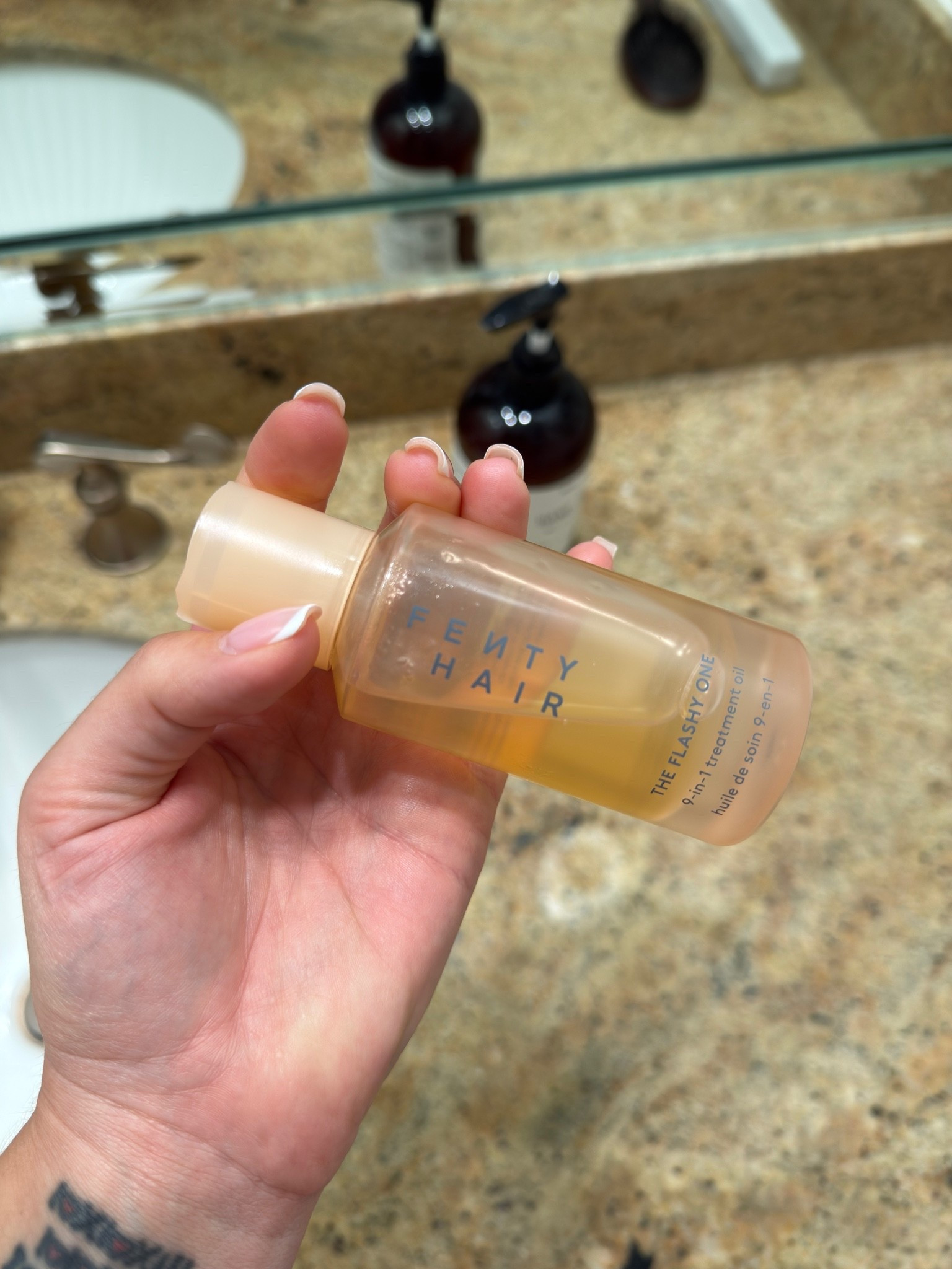 Nine things in one bottle for $32 — I did the math and it's a good deal.
Fenty Hair's The Flashy One is a bi-phase treatment oil that moisturizes, smooths frizz for up to 72 hours, seals split ends, reduces breakage, and protects up to 450°F of heat. That last one matters if you're using hot tools regularly and skipping a heat protectant because you don't want another step. This is the step that covers it.
I tried it and liked it enough to say something about it, which is the bar. At $32 it's genuinely accessible for what it does — and for Houston humidity specifically, 72 hours of frizz control is not a small promise.
Works on all hair types, which means I can recommend it without the usual caveats. #beauty #hairoil #fenty 

 