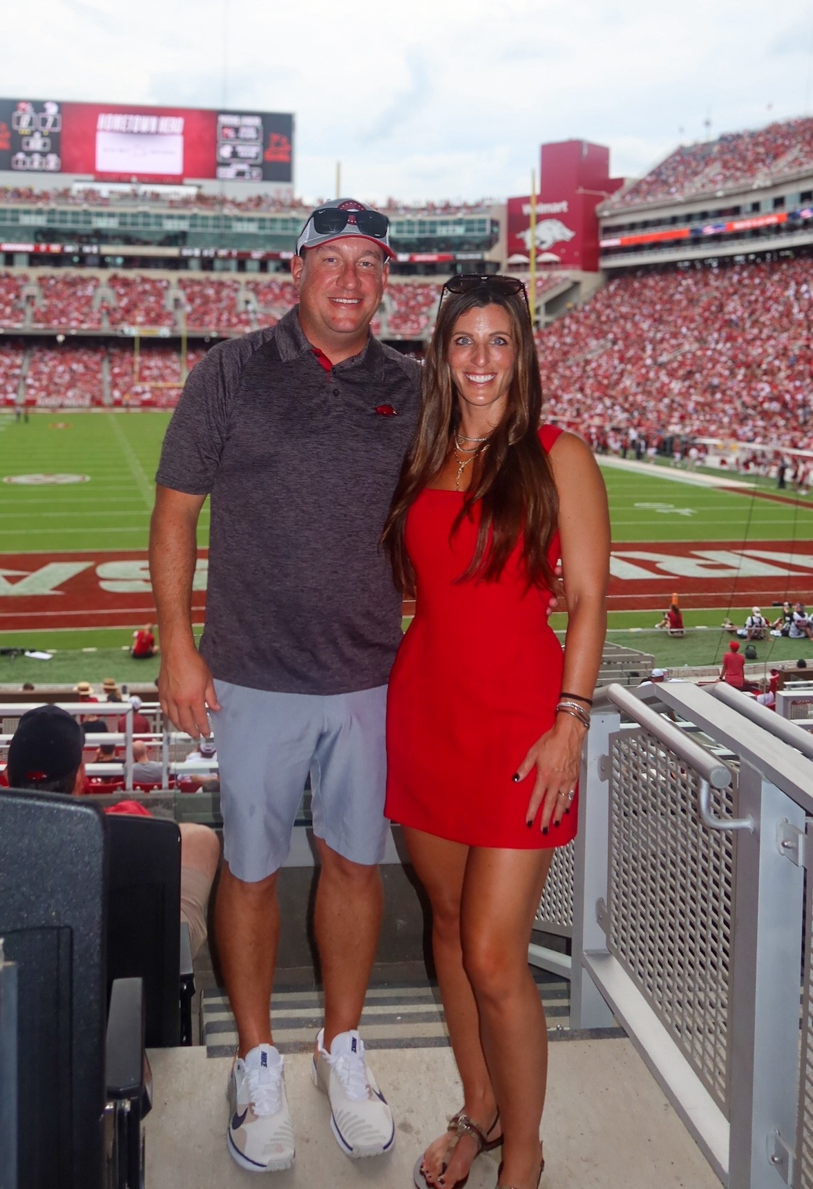 🏈🐗 First Razorback Football Game of the Season!
Celebrating a big W at Razorback Stadium in gameday-ready outfits perfect for SEC football, tailgates, and stadium style inspo! 🔥

👩‍🦰 Her Outfit:
	•	🔴 Red Square-Neck Mini Dress | Game day dress • Tailgate outfit • SEC style • Fall football fashion
	•	👡 Gucci Metallic Flat Sandals | Designer sandals • Minimalist thong sandals • Game day shoes
	•	🕶️ Classic Aviator Sunglasses | Ray-Ban aviators • Designer sunglasses women • Stadium chic
	•	💎 Gold Necklace Stack | Layered gold jewelry • Dainty necklace stack • Gameday jewelry
	•	🪙 Mixed Metal Bracelet Stack | Arm candy • Layered wrist stack • Minimalist accessories

👨‍🦱 His Outfit:
	•	👕 Charcoal Polo Shirt with Razorback Logo | College football polo • Tailgate top • Razorback gear
	•	🩳 Light Gray Performance Shorts | Athletic shorts • Game day casual
	•	👟 White Nike Sneakers | Casual athletic shoes • Stadium comfort

📍Location: Razorback Stadium • Arkansas Razorbacks
🥳 Occasion: First football game of the season • Tailgate chic • SEC football style

🔑 SEO Keywords:
#GamedayOutfit #TailgateFashion #CollegeFootballStyle #FootballGameOutfit #SECStyle #RedDressOutfit #DesignerSandals #GucciSandals #FallOutfitInspo #StadiumStyle #CouplesOutfit #HisAndHersStyle #LTKStyle #LTKGameDay #LTKFallFashion

#LTKActive #LTKOver40 #LTKSeasonal