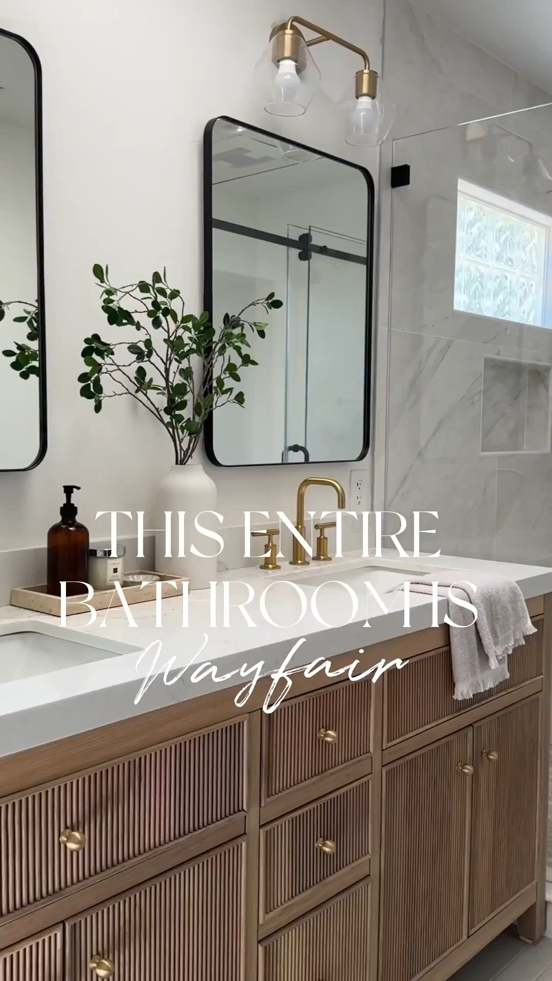 This entire beautiful bathroom is from Wayfair.
We used so many affordable options, yet were able to achieve this high-end look.
Love the reeded detail of this prefab wood vanity, which comes with multiple different countertop options. My favorite part could be the medicine cabinet. So stylish and functional. Love how the neutral colors of the tile provide a serene vibe.

Marble tile, large format, tile, gray tile, wood, vanity, brass faucet, brass shower system, black rectangle, mirror, medicine cabinet glass, sconces, brass, sconces, glass, shower door, sliding glass door.

#LTKSaleAlert #LTKHome