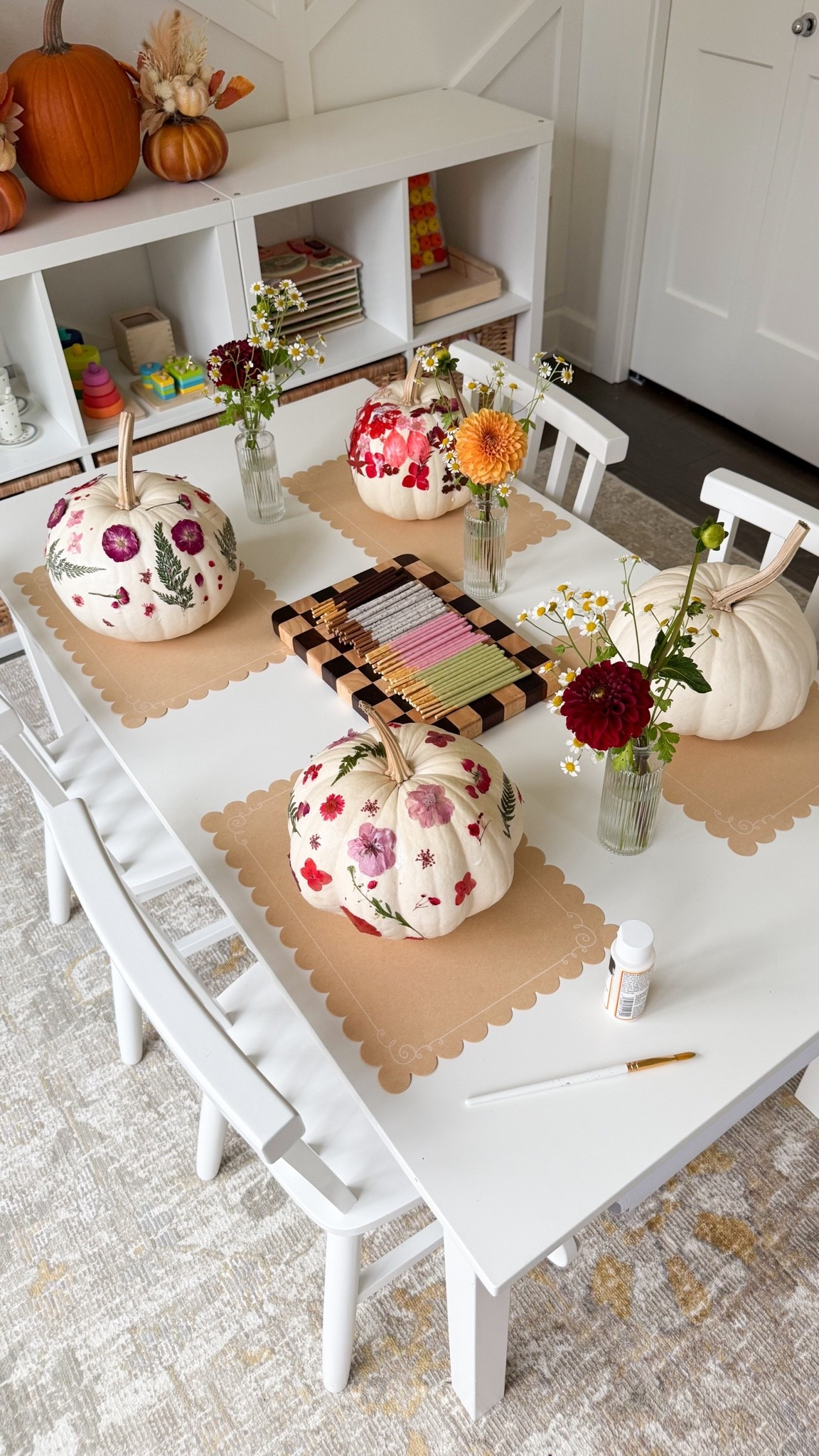 Petals, pumpkins, and Pocky!
We made the cutest pressed flower pumpkins after school. This was such a fun activity to do with the girls, and I love how pretty our pumpkins turned out.

Paint brushes, pressed flowers, Mod Podge glue, Pocky, kids chairs and table, rug, bud vases, chop board

#LTKhome #LTKkids