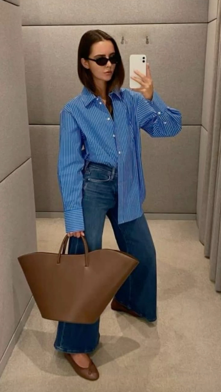 This elevated everyday outfit pairs a classic blue striped button-down with dark wash jeans and rich brown leather accessories for a polished casual look.
Structured pieces like the oversized tote and tailored shirt instantly make denim feel sophisticated while still staying comfortable and effortless. 

 #LTKootd #LTKmomlife