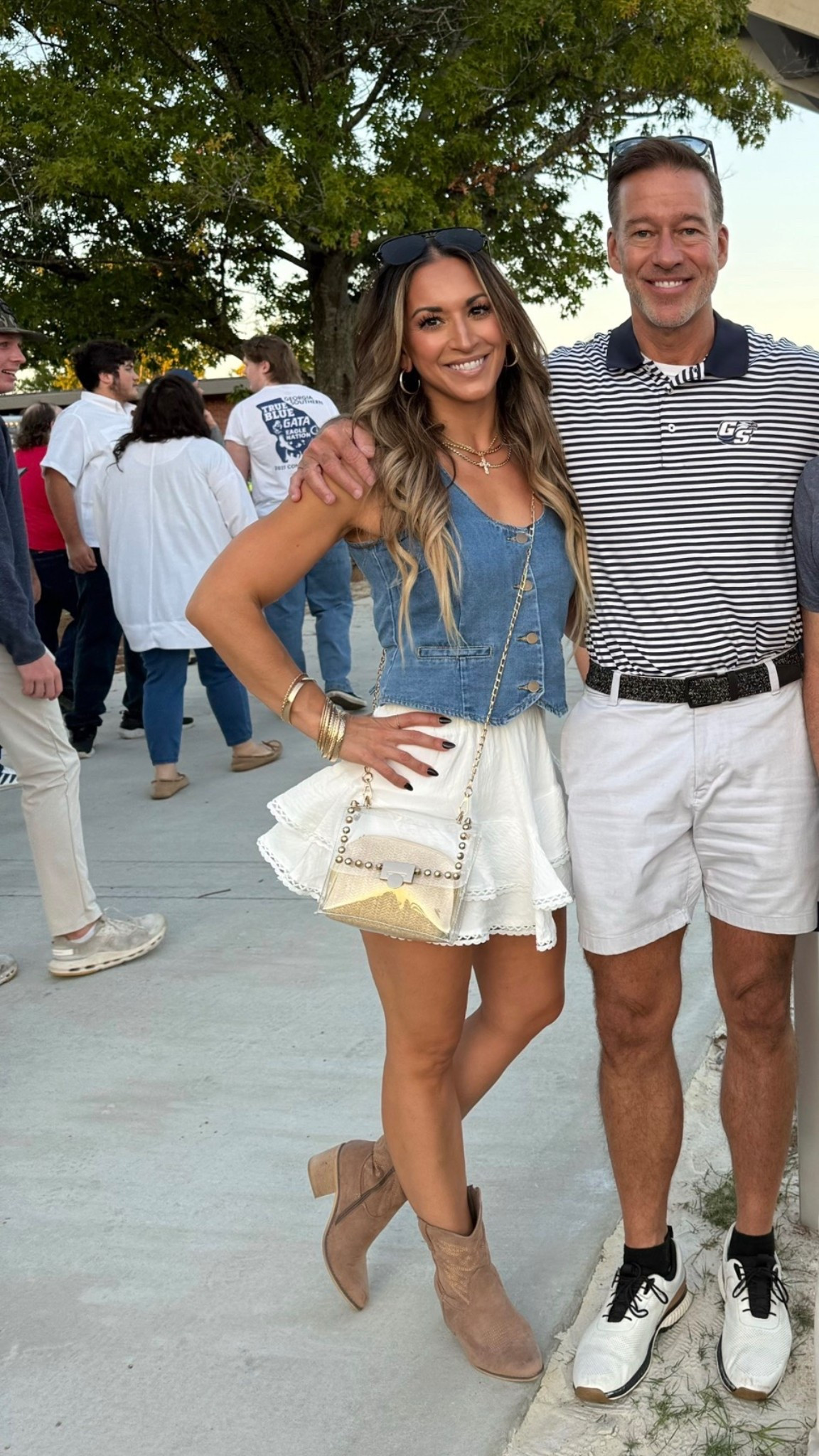 Game day outfit. Country concert. White skirt. White skirt. Ruffle skirt. Boho skirt. Flowy skirt. Skirt with built in shorts. Denim vest. Western booties. Cowboy boots. Cross necklace. Layered necklaces. Gold necklaces. Hoop earrings. Gold hoops. Clear bag. Studded clear bag. Aviators. Black oversized sunglasses. Brown boots.

#LTKFindsUnder100 #LTKOver40 #LTKFindsUnder50