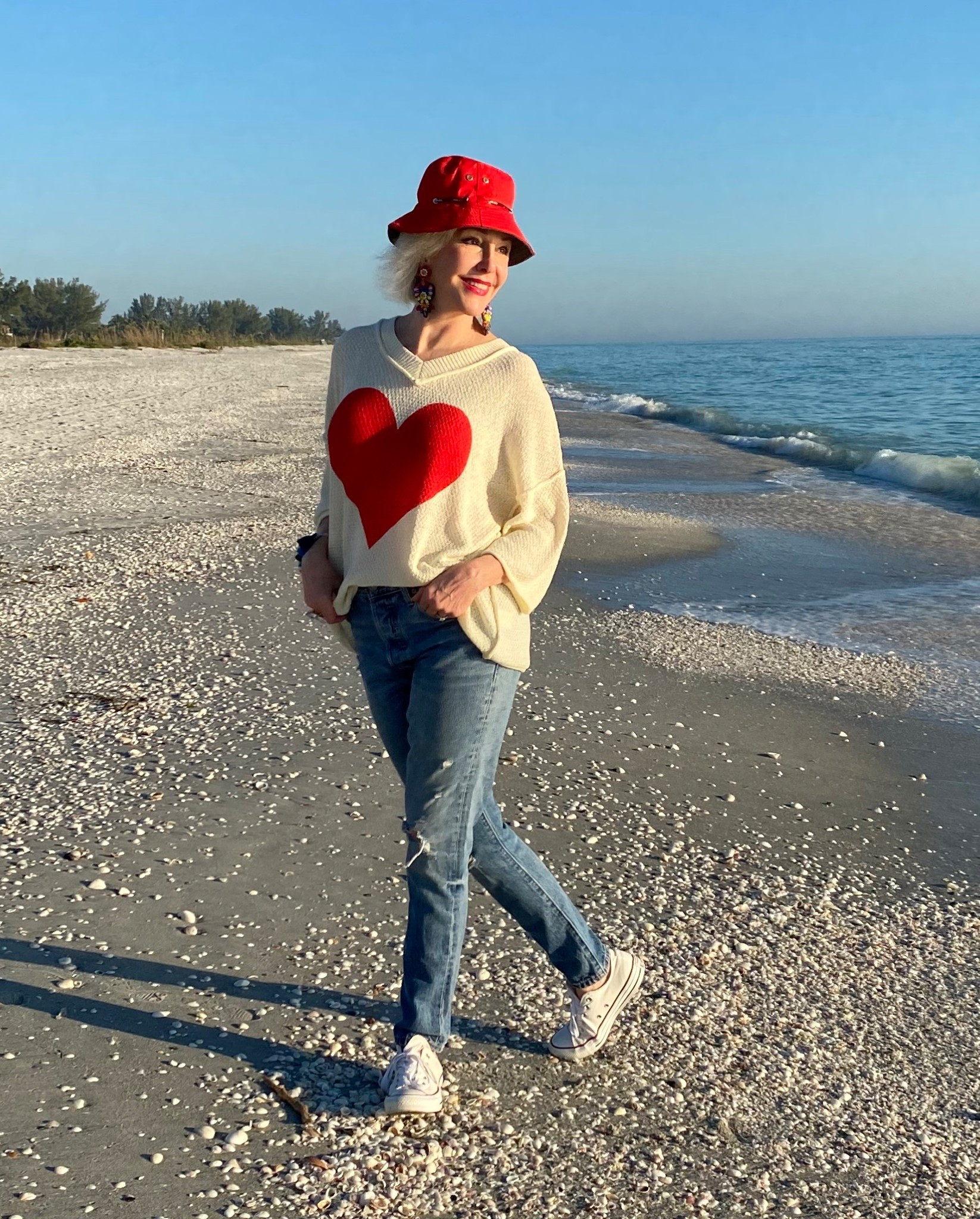 Made from a lightweight knit fabric, this cute heart sweater offers a soft and comfortable feel, perfect for transitional weather. The breathable material ensures all-day comfort without feeling too heavy.
Chuck Taylor Converse low top sneakers.
Straight leg distressed Jeana’s
Red fisherman’s bucket hat, Valentines Day Ouitfit, 

#LTKootd #LTKValentine #LTKOver40