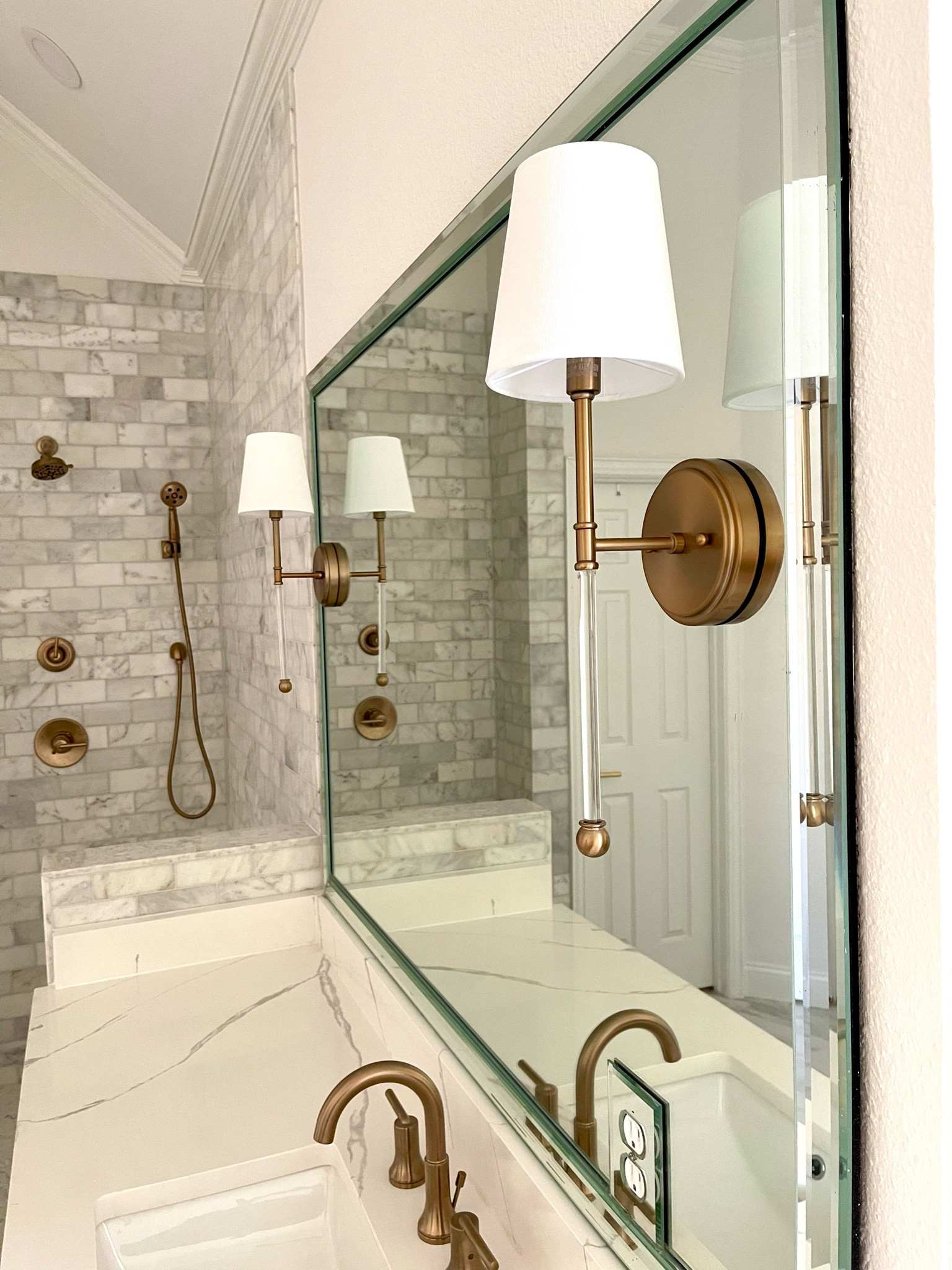 These wall sconces match perfectly with the finish on @delta champagne bronze. And also match perfectly with the large chandelier in my bathroom! #bathroomreno #delta #champagnebronze 

#LTKstyletip #LTKunder100 #LTKhome