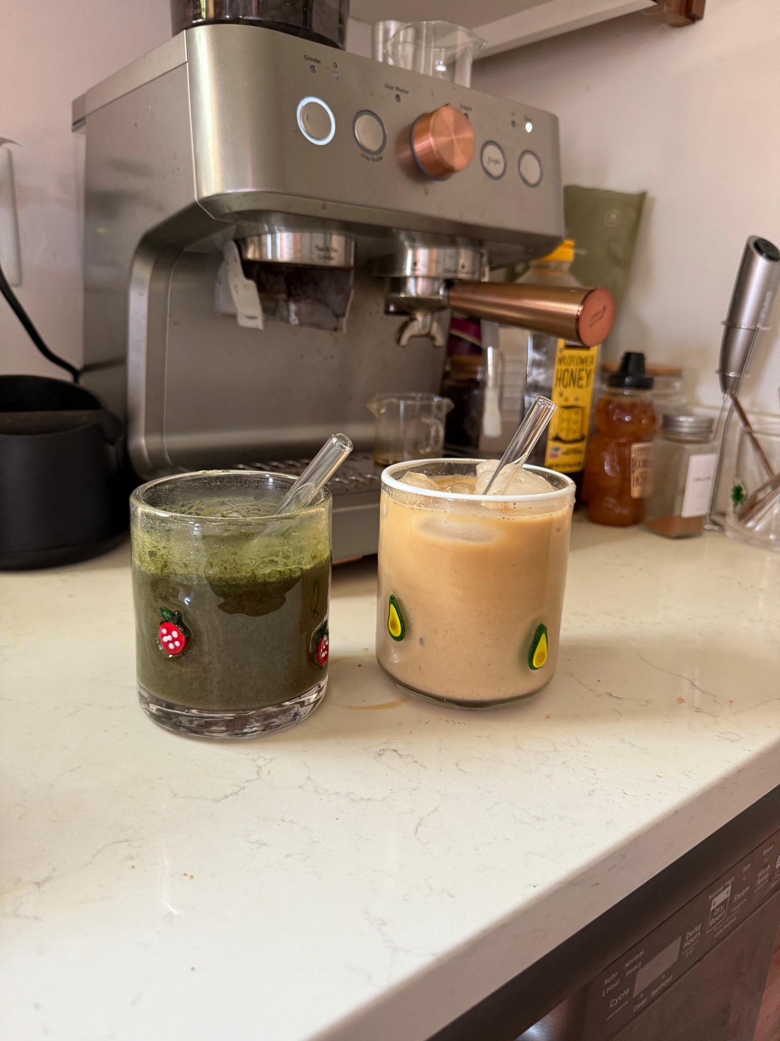 Cozy at-home coffee bar goals ☕✨ This setup features a sleek espresso machine with warm rose gold accents, surrounded by everyday essentials like honey, frothers, and fun glass cups with cute fruit decals. Whether you're whipping up an iced matcha or a creamy latte, this corner blends functionality with charm—perfect for your morning ritual or afternoon pick-me-up. #CoffeeBarSetup #HomeCafeVibes #MatchaAndLatte #EspressoMachine #CozyKitchenIdeas #PinterestKitchenGoals

#LTKFamily #LTKHome