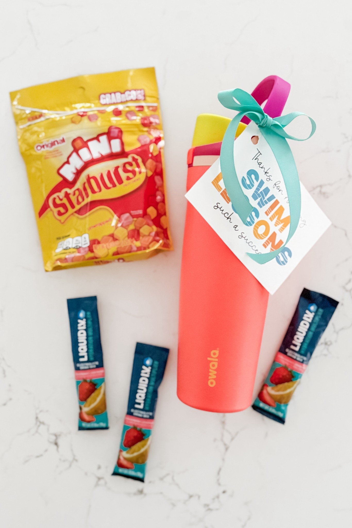Our beloved swim instructor is moving away so we wanted to give her something to show our appreciation of how hard she’s worked with Sophie. 🐠
We put a few fun treats inside a water bottle with a cute tag and coordinating ribbon — I love how it turned out! #LTKGifting

#LTKKids #LTKSwim