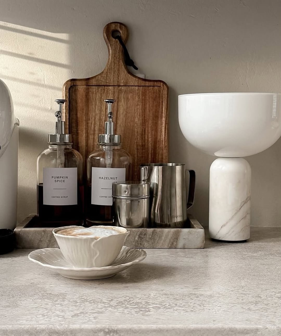 Slow mornings and cozy corners — this is my favorite little ritual. ☕✨
There’s something so comforting about a homemade latte with just the right touch of pumpkin spice or hazelnut syrup.
I styled this coffee station with warm woods, marble textures, and clean neutrals to keep it calm and inviting.
Every detail, from the ripple cup to the syrup bottles, makes the space feel both functional and beautiful.
If you’ve been dreaming of a cute coffee nook, this is your sign to create one — and yes, everything is linked on my LTK! 🤍

#CoffeeCorner #HomeCafeVibes #NeutralAesthetic #LTKHome #LTKFinds #MorningRituals #HomeInspo #KitchenDetails #CoffeeStation #CalmSpaces #SoftMornings #WonenMetLef #StyledSpaces

#LTKSeasonal #LTKHome #LTKU