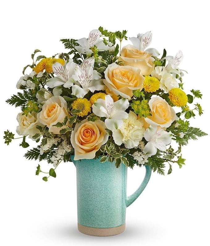 Celebrate Mom with a vibrant bouquet. Radiating the vibrant spirit of beauty, this charming bouquet boasts sunny yellow roses, paired with delicate white alstroemeria and soft peach carnations in a glass gathering vase. Adorned with chrysanthemums in cheerful yellow and hints of sinuata statice, it exudes the essence of joy. Enhanced by beautiful floral greenery, this bouquet captures the beauty of the season in full bloom. ON SALE and under $80. Available in three sizes - regular, deluxe (as shown), and premium.

Includes:
• Yellow Roses
• White Alstroemeria
• Peach Carnations
• Yellow Button Spray Chrysanthemums
• Floral Greens
• Glass Gathering Vase
• Complimentary Gift Message

#LTKMothersDay #LTKHome #LTKSaleAlert