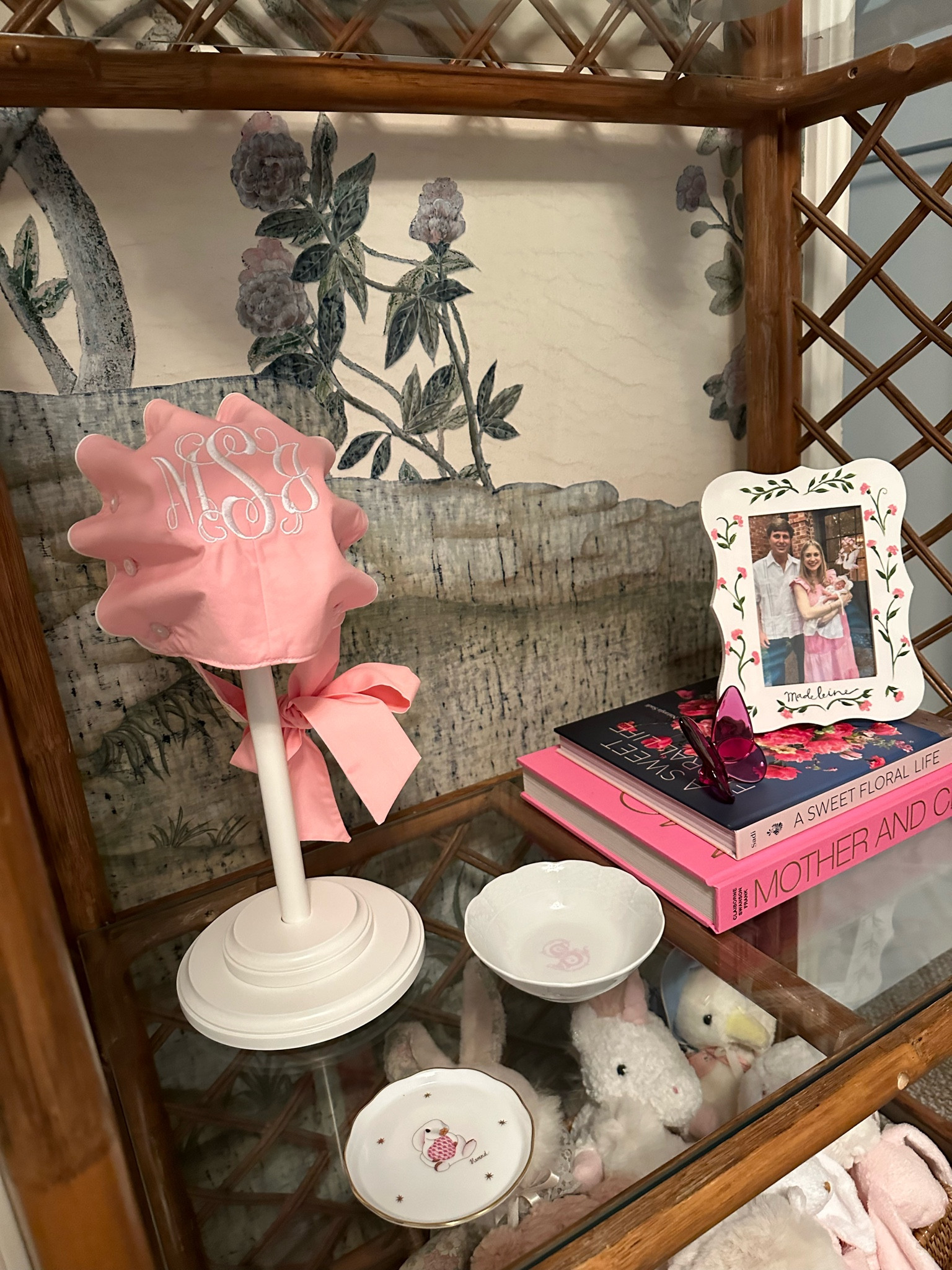 One part of Madeleine’s etagere in her nursery! It has all things pink and girly with some favorite coffee table books, dishes, and bonnet! We found her etagere on FB marketplace but linked some other beautiful similar home decor finds! 🩷 nursery inspo, nursery, baby girl, floral decor, interior designer 

#LTKHome #LTKBaby