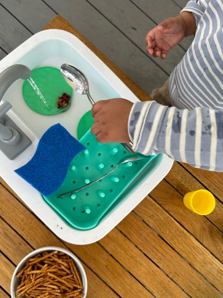 This play kit from Lovevery has been our favorite for months. The sink is so cute! My almost three year old can spend a good 45 minutes "washing dishes and cooking”