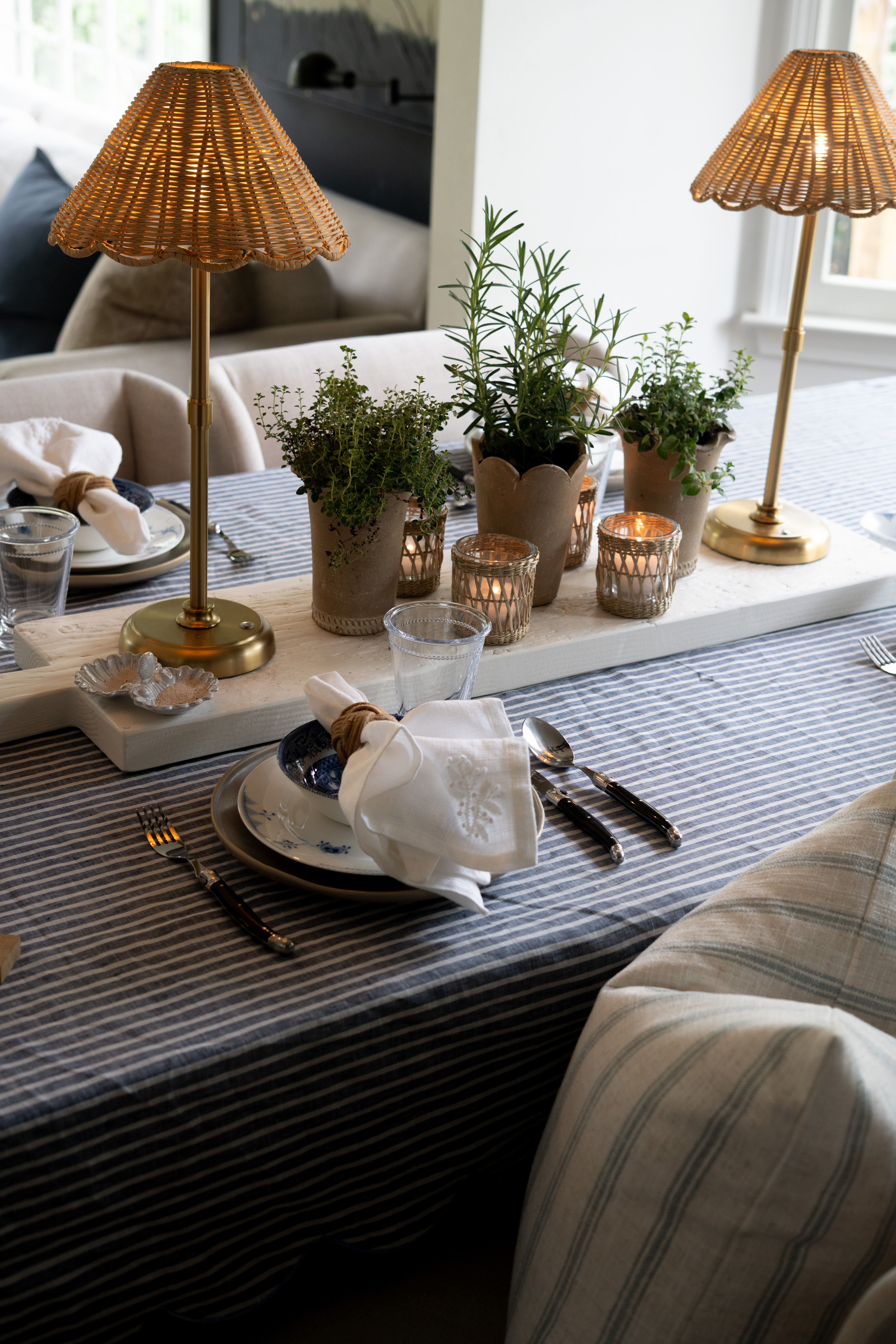 EEEKK!! I am absolutely loving this layered tablescape moment. The combination of blue and white dinnerware, striped linens, and warm ambient lighting creates such an inviting and elevated look. I always gravitate toward mixing natural textures like woven shades, wood, and ceramics to bring depth while still keeping everything clean and timeless. This is the kind of setup that makes everyday hosting feel intentional, organized, and effortlessly beautiful.  

 #LTKSeasonal #LTKOver40 #LTKHome