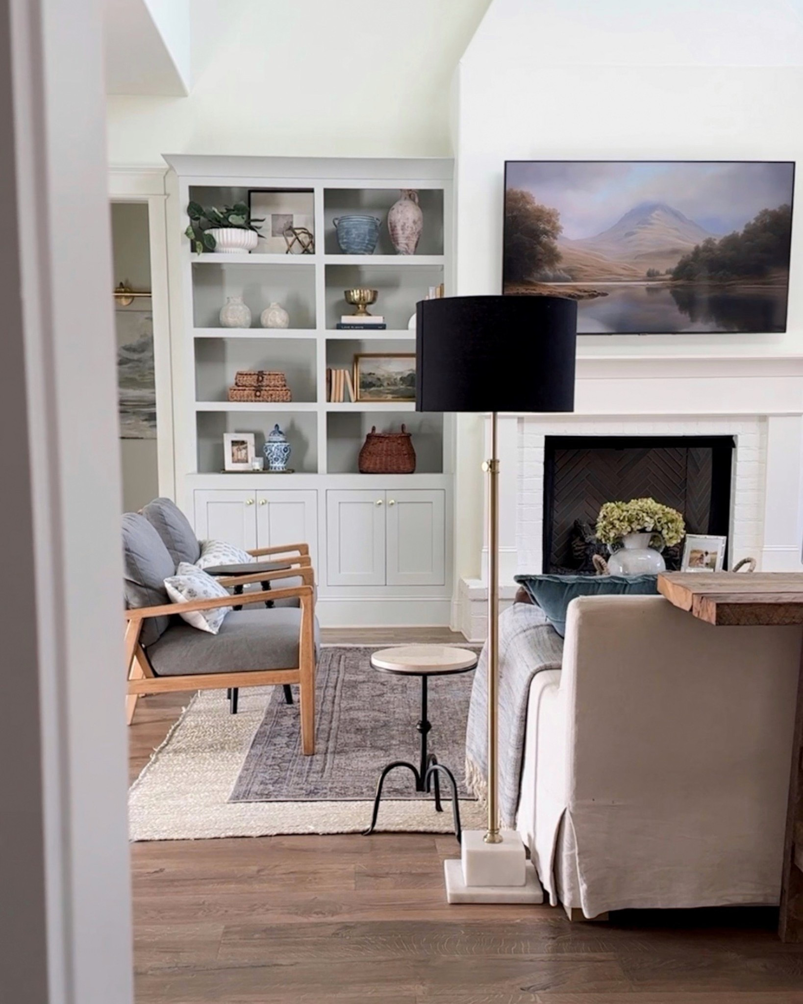 Modern classic living room 🤍 Last week I refreshed the coffee table and shelf styling. I love how this room is off the kitchen and serves as the heart of our home  

#LTKHome