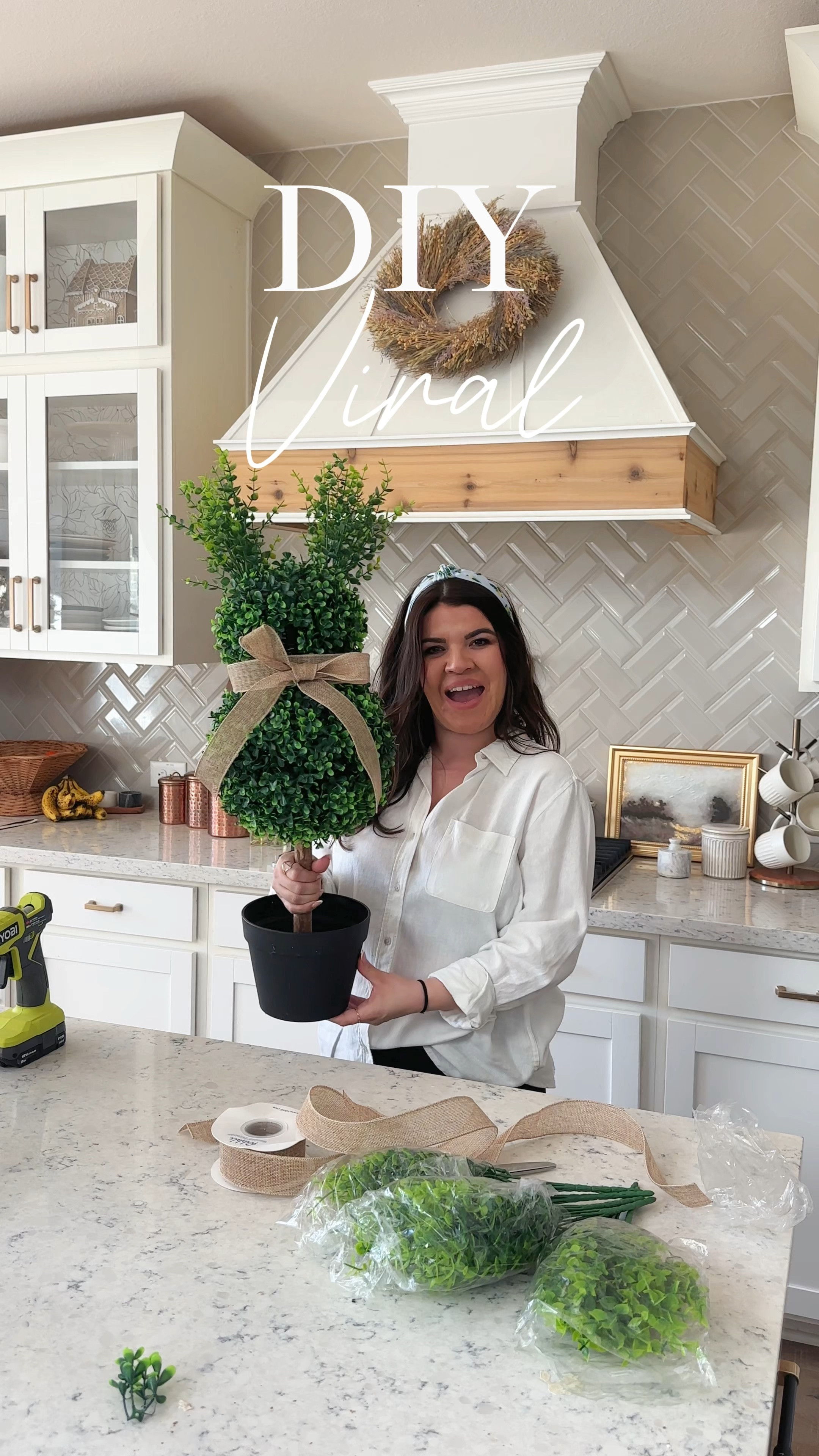 Let’s make the VIRAL bunny topiary. Seriously such an easy and cute diy! You can make your own topiary now and customize it how you like.. and it comes out less expensive than the other bunny topiary’s out there.. that’s if you are lucky
to grab one while it’s in stock! 
Supplies I used:
Boxwood topiary sphere tree 
Scissors
Hot glue gun
Burlap ribbon or any ribbon of your choice 
Boxwood stems for the ears 
How I made the bunny!
First you want to take out your staples for the bottom sphere, it splits in half, you can disconnect the sphere to make sure all staples have been removed and you can freely move it up or down.
Secondly slide your sphere to where it fits right under the top sphere. Mine stayed in place but you can easily add some hot glue to the bottom to keep the sphere in place.
Third you will place the stems in the top sphere. This slid in very easily . These will be your ears. 
Finally add a ribbon and a bow of your choice and you’re done! 
You can add your cute bunny to a planter of your choice! 

#LTKSeasonal #LTKHome #LTKWatchNow