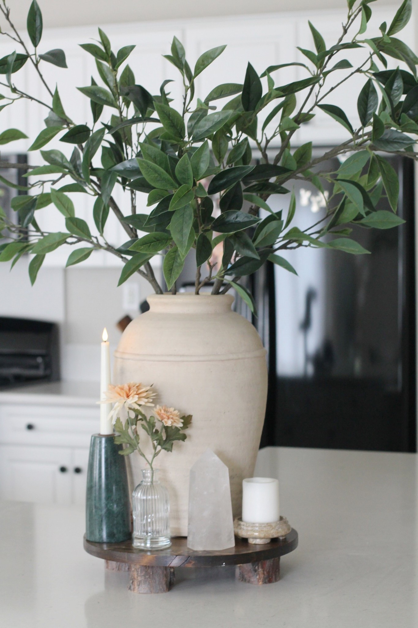 Spring kitchen island decorating
Beige vase, green stems from Pottery Barn
Orange flowers from Target
Green marble candlestick holder 
Quartz Crystal and candles
Wooden stand 
White kitchen 
Organic modern home decor 

#LTKSpringSale #LTKSeasonal #LTKHome